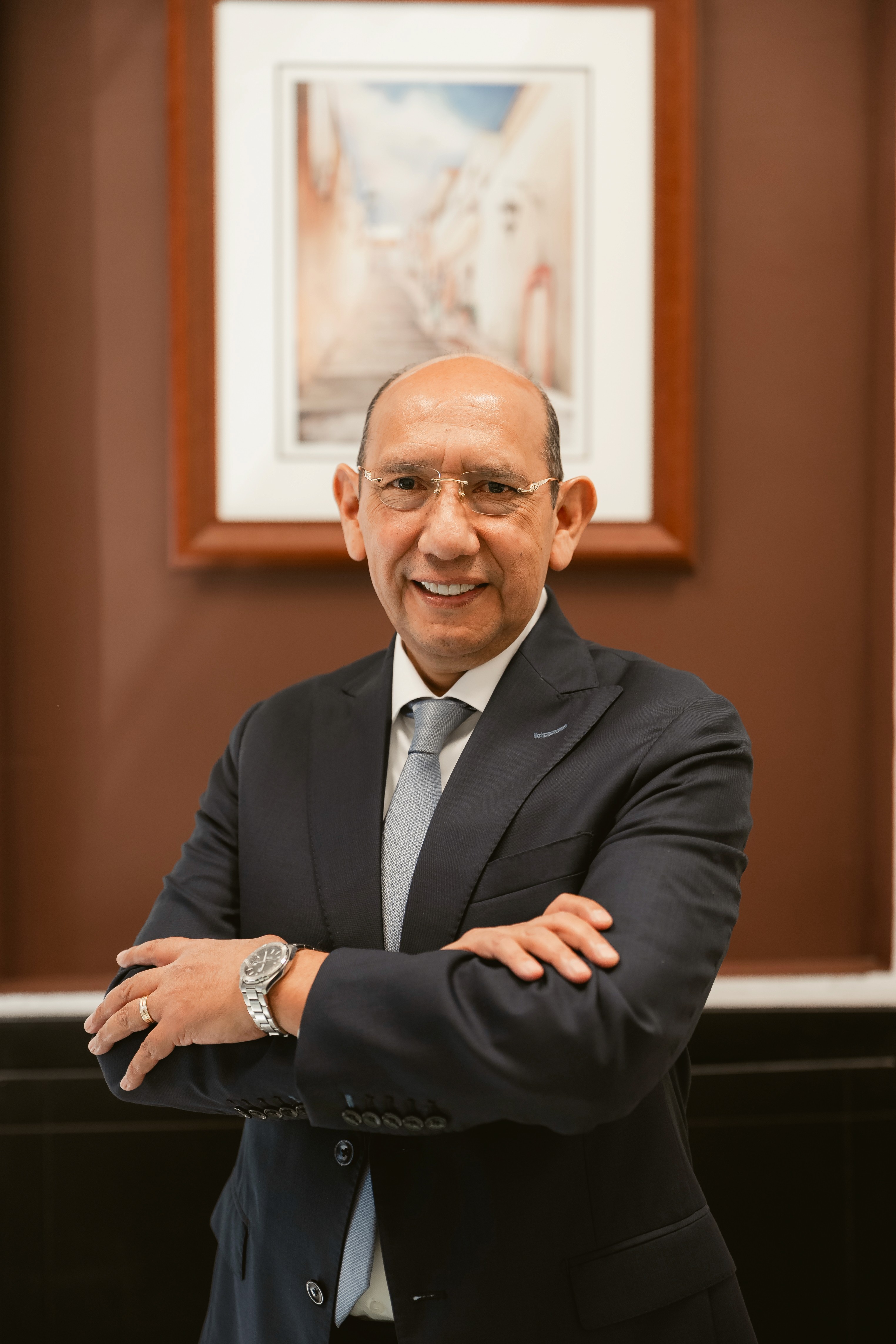 a man in a suit standing with his arms crossed