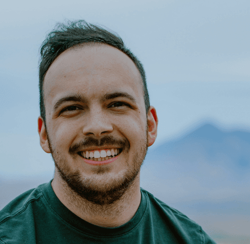 A man sitting on top of a wooden bench