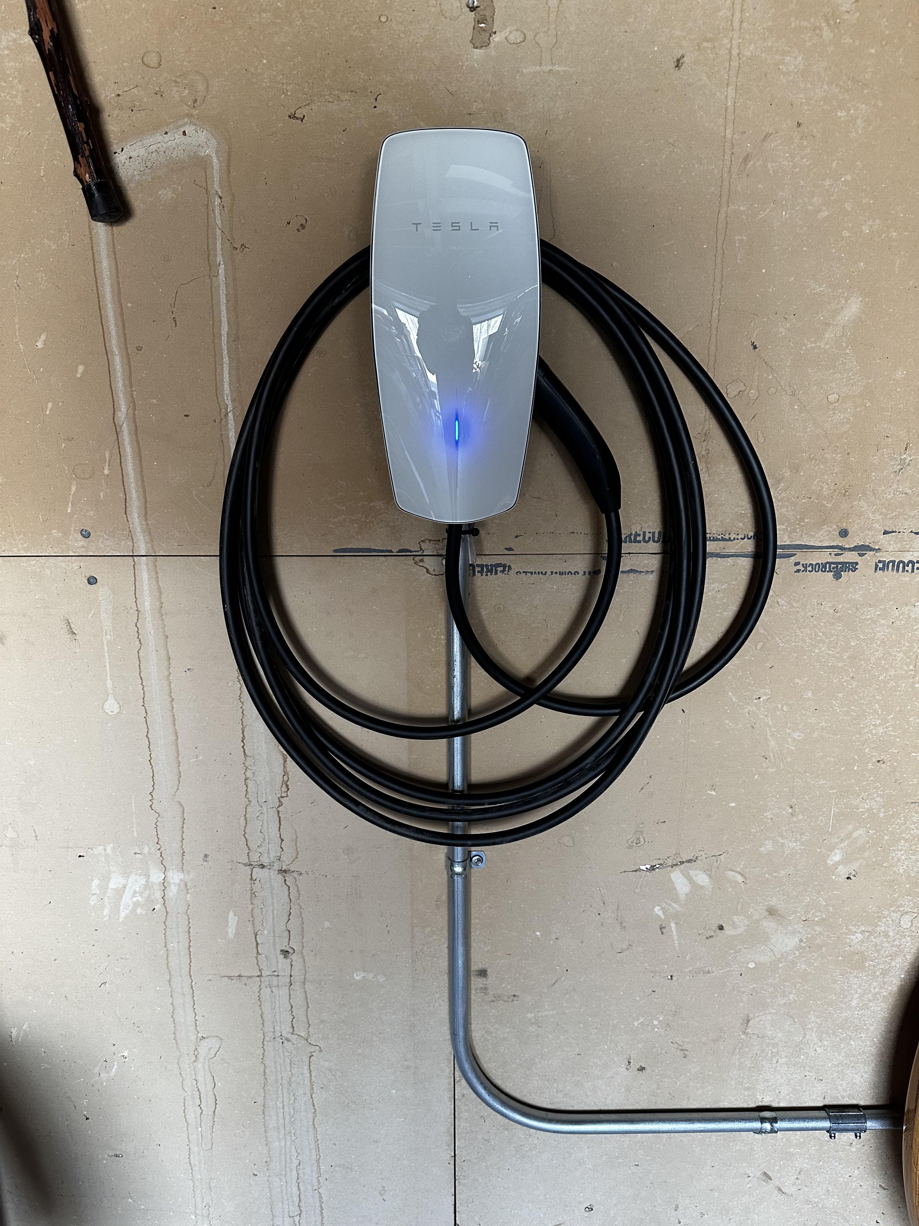 Tesla wall connector with coiled charging cable