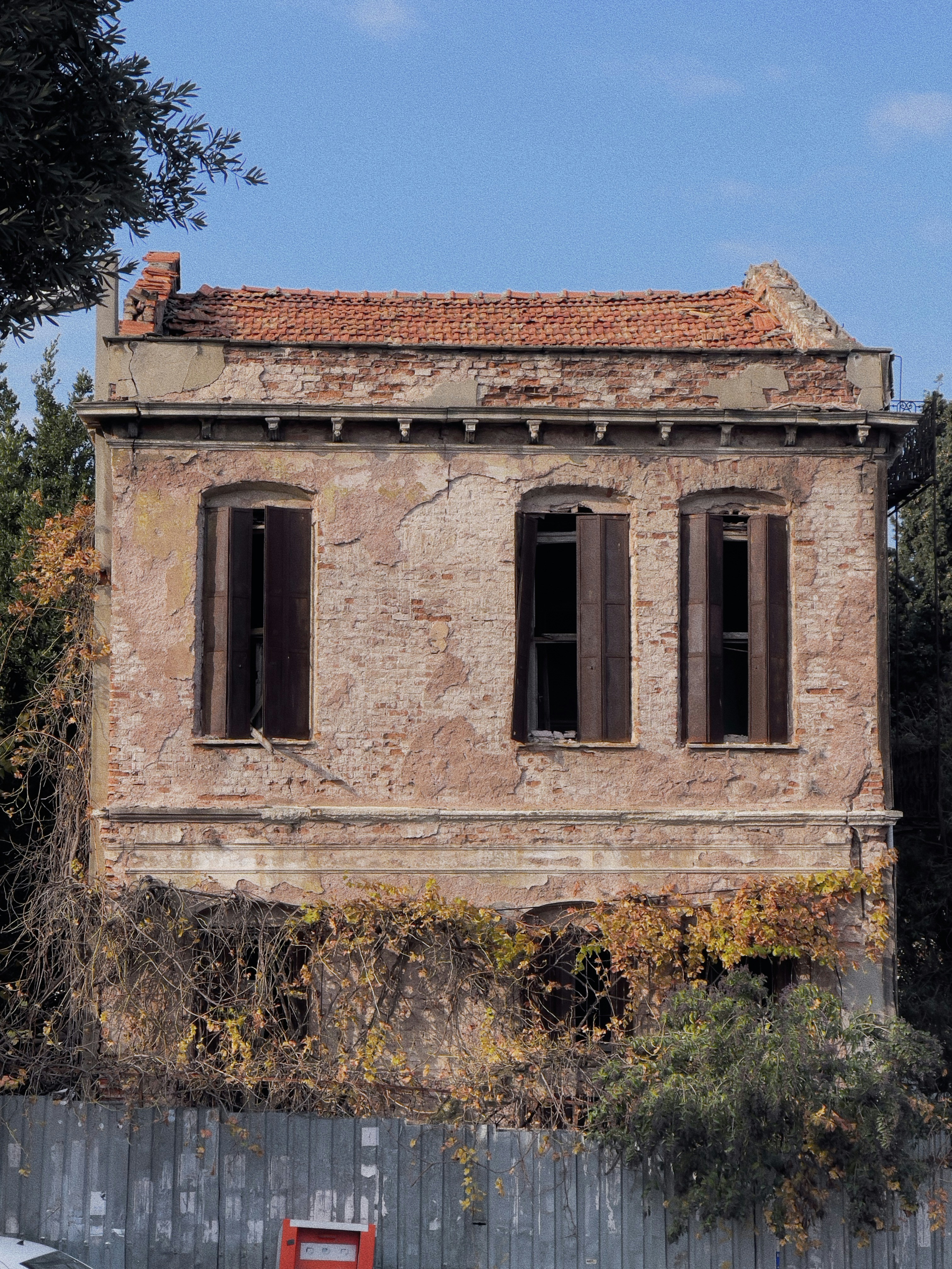 an old building with a red bench in front of it