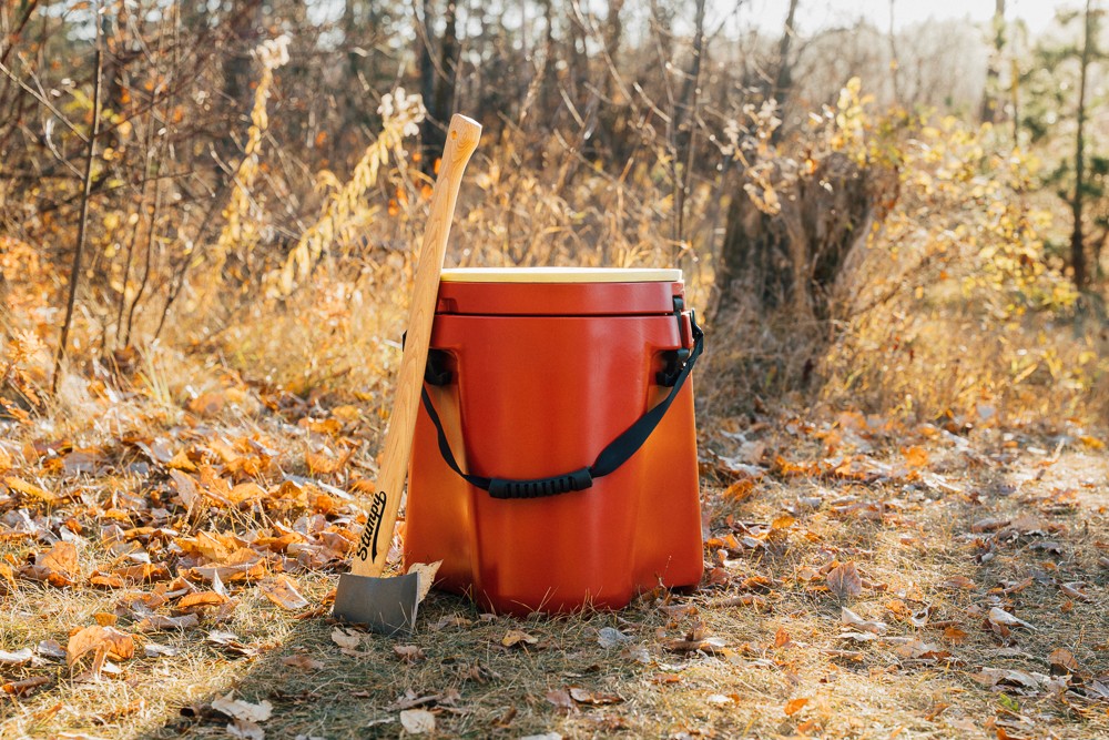 a axe leans on a wood chopping block 