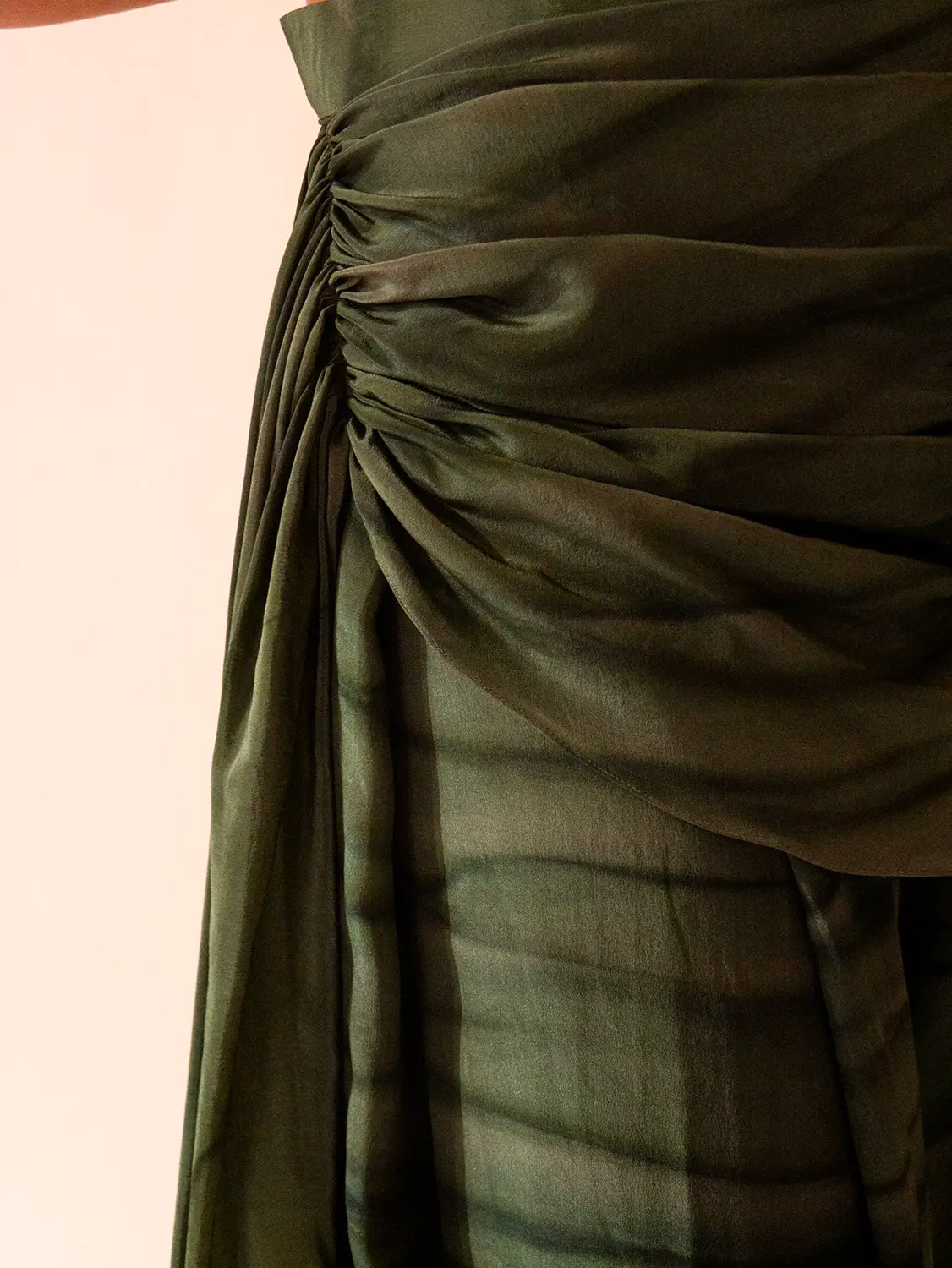 They feature asymmetrical tucks and fluid folds pinned at varying levels,