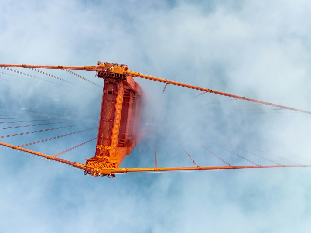 An orange bridge as seen from above