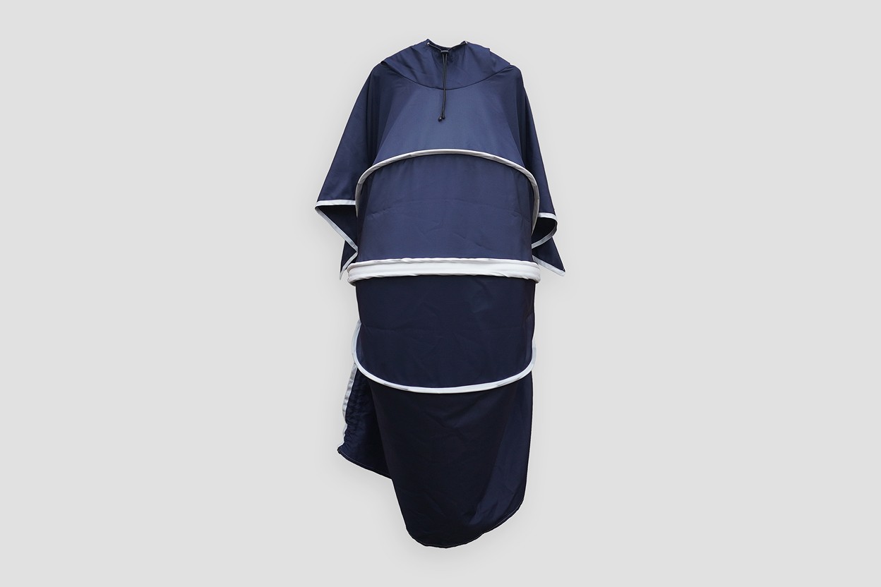 Front product view of the 55 Minutes Wheelchair Poncho, featuring a hood and flexible ribs that provide full head-to-toe coverage