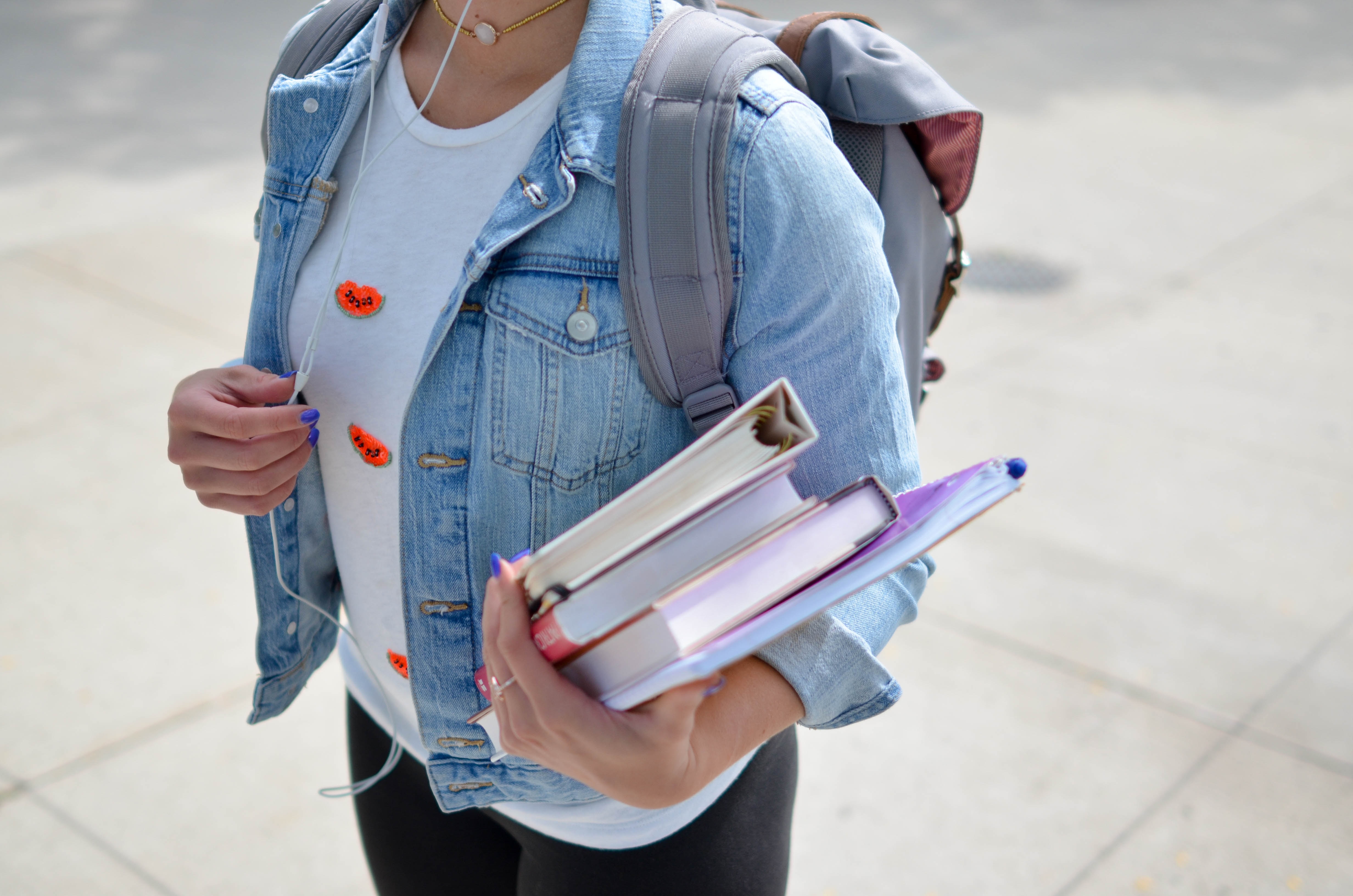 student taking books to class - how to study for biology