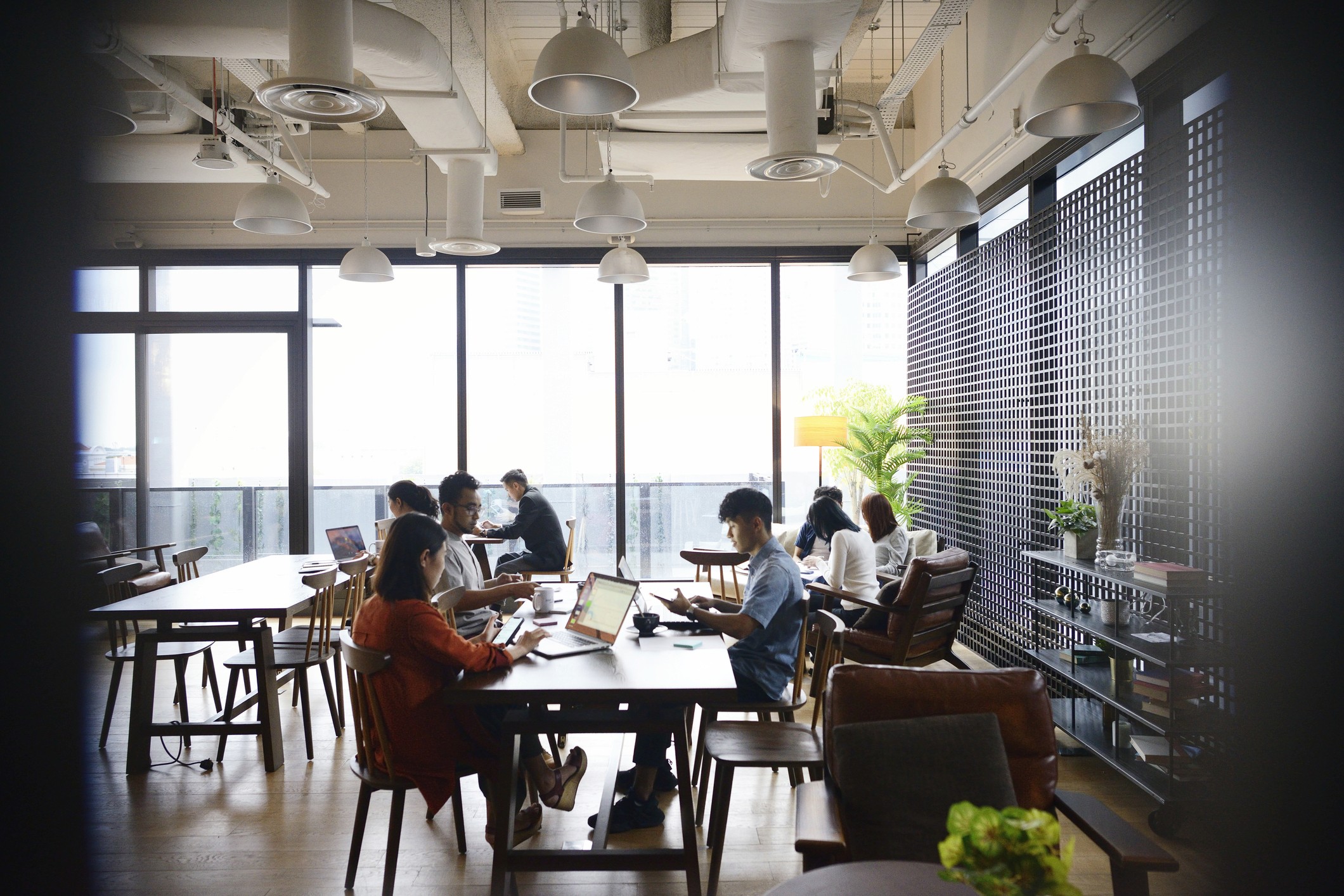 Zoomed out view of Inventive employees at work in a shared office space.