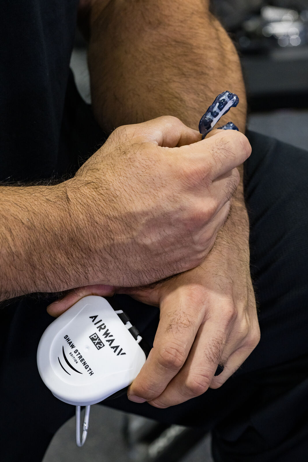 AIRWAAV shoot, the mouthpiece case clipped in hand, close up