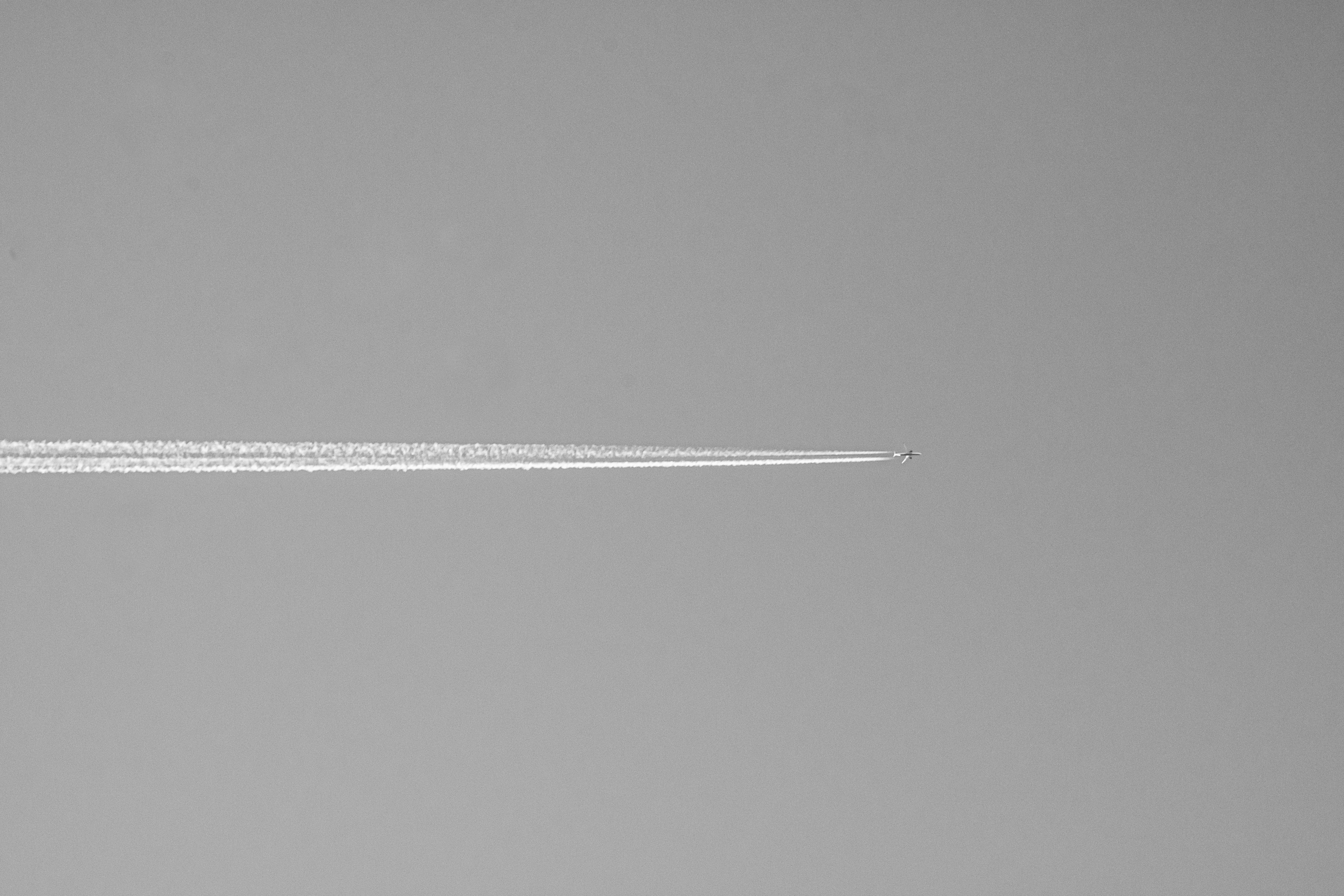 Airplane contrail across a clear sky