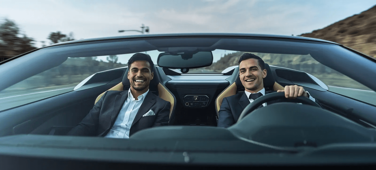Two happy men driving a sportscar with a joyful expression, ideal for car rental adventure promotions.