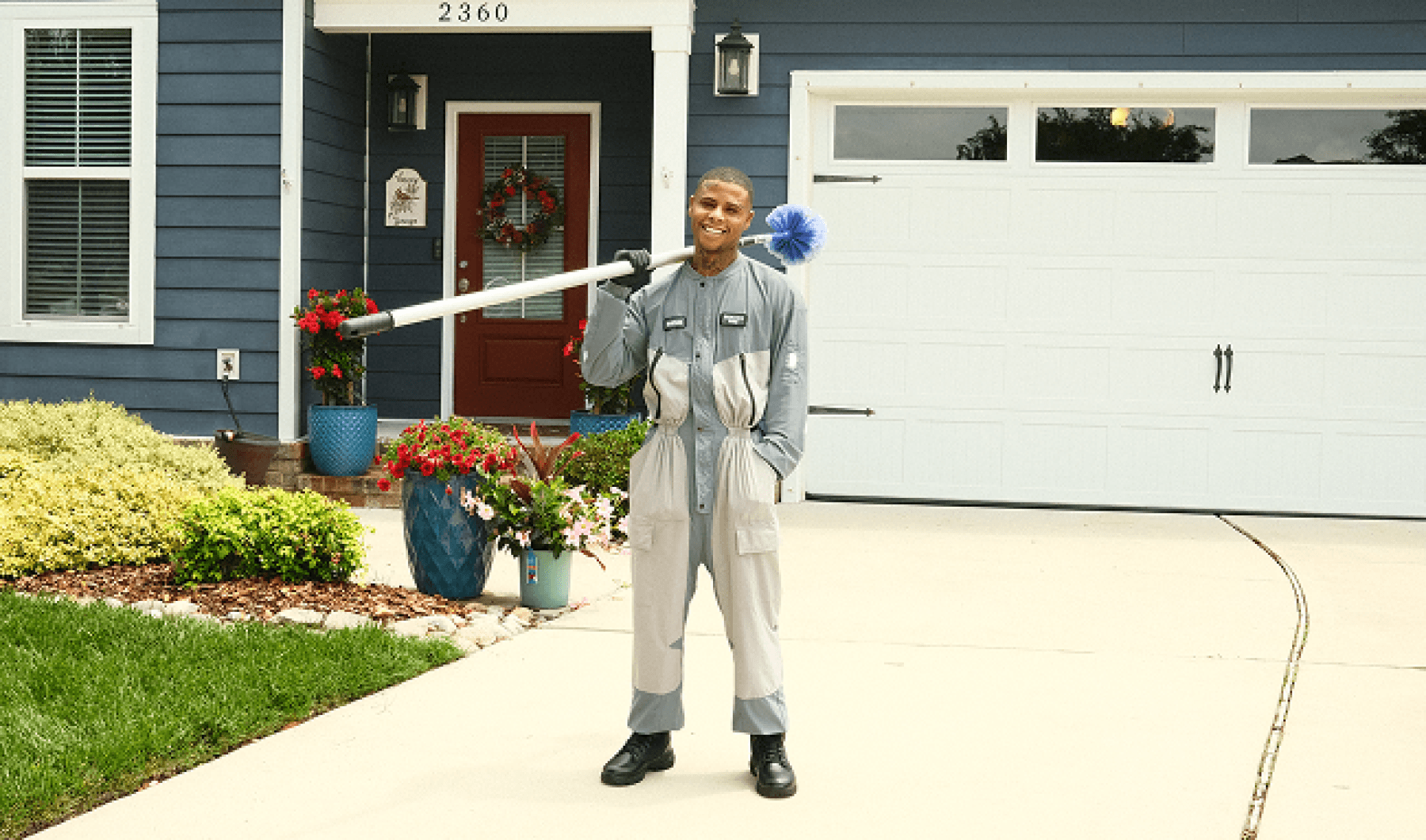 Pest control technician servicing a home