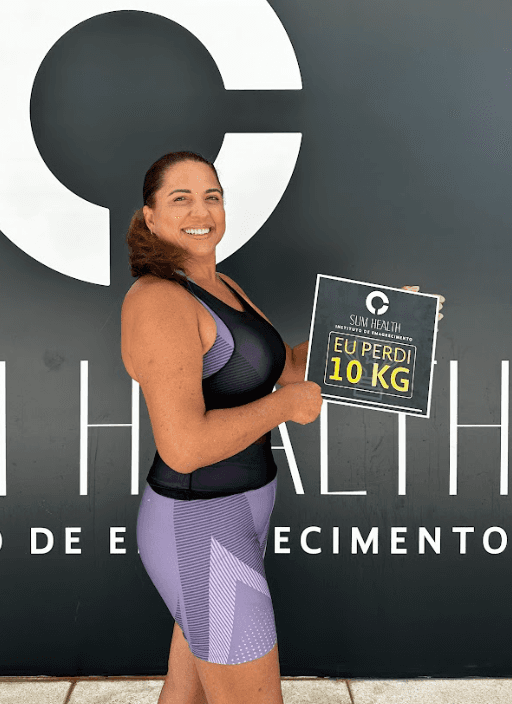Close-up of a dark green leaf showing its textured surface and central vein against a muted background.