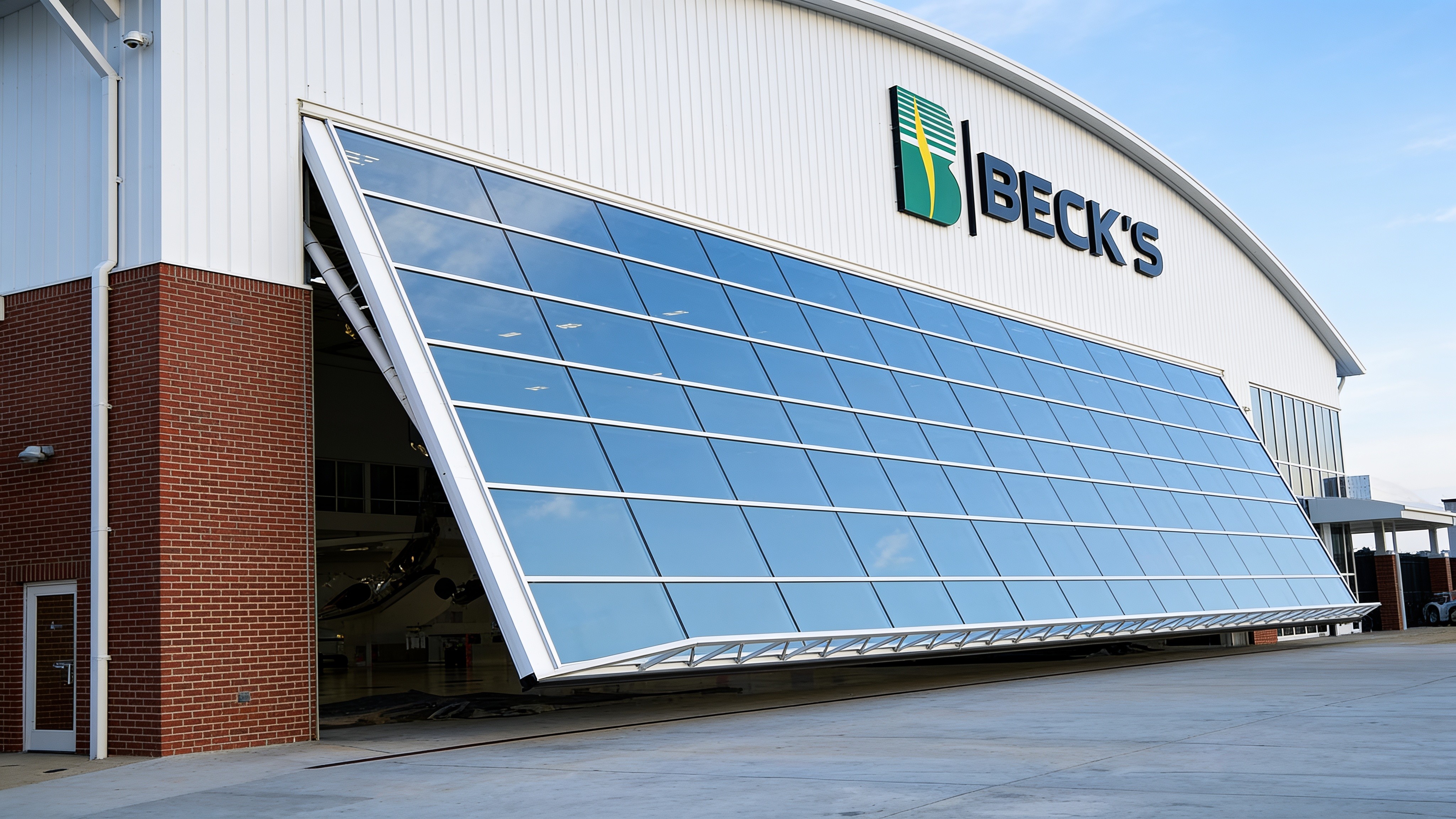 110-foot glass-clad hydraulic aircraft hangar door, partially open