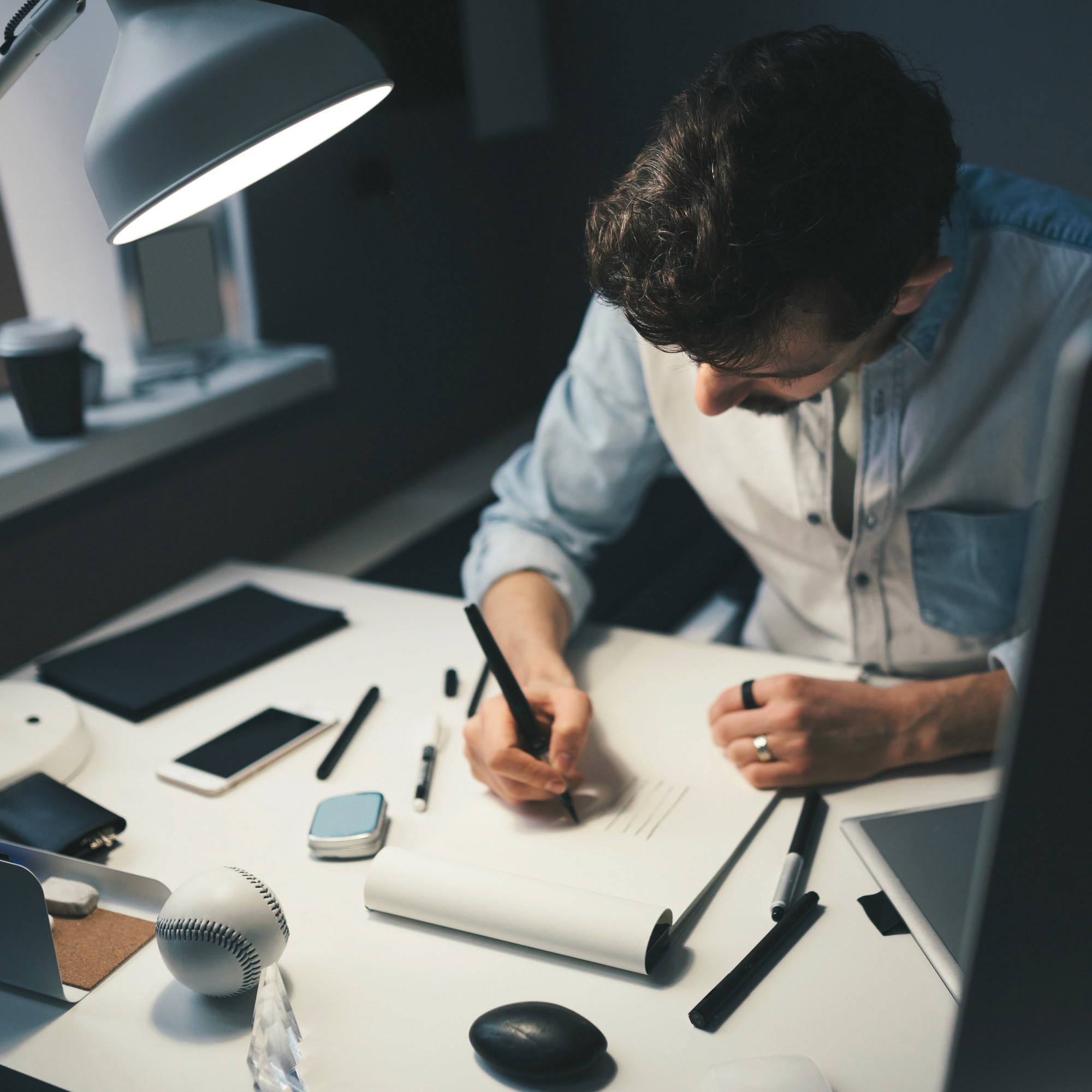 Black cosmetic product bottle against a dark background