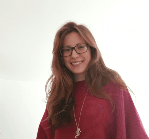 man smiling while sitting on floor during daytime