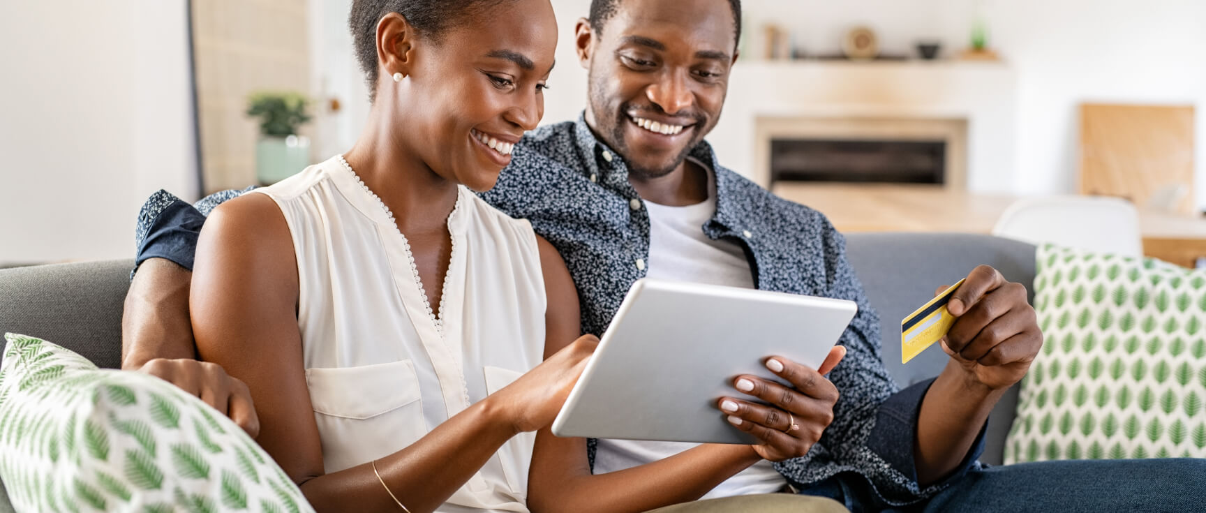 happy couple using their line of credit looking at tablet together