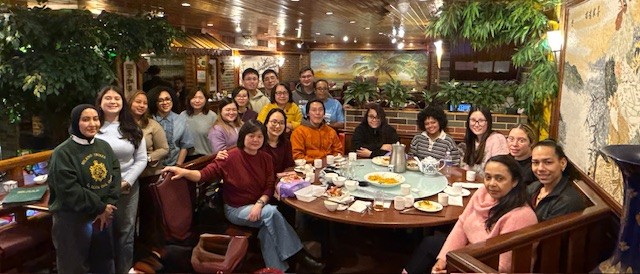 A group of Senior Services staff sit around a restaurant table.