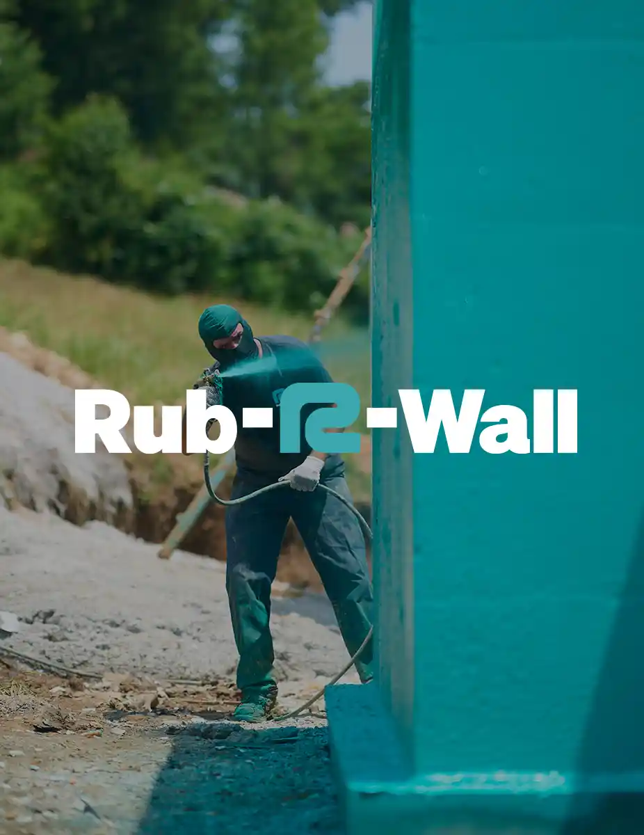 A man spraying Rub-R-Wall waterproof coating on a concrete foundation with overlaying Rub-R-Wall logo