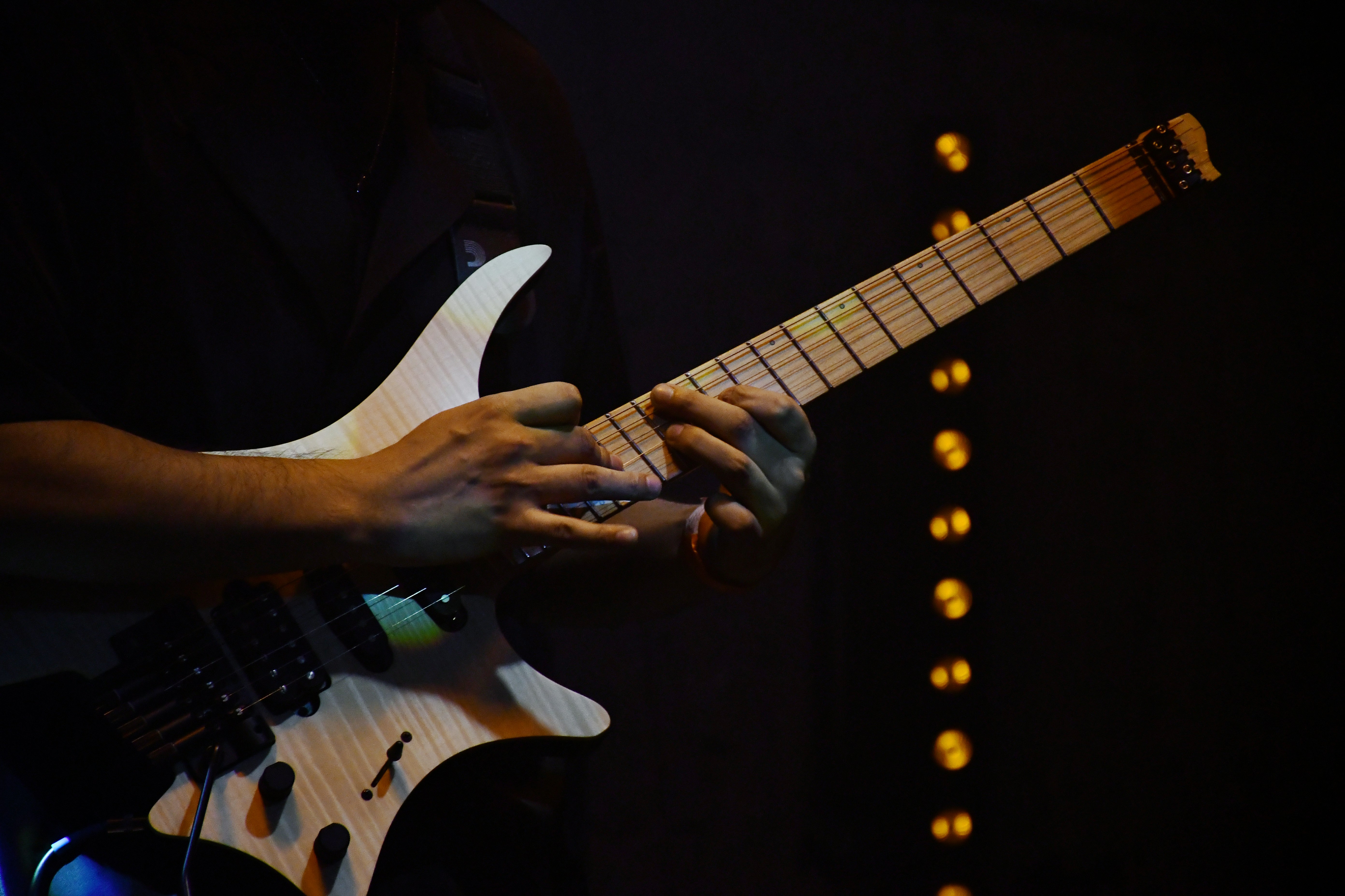Man fretting a guitar