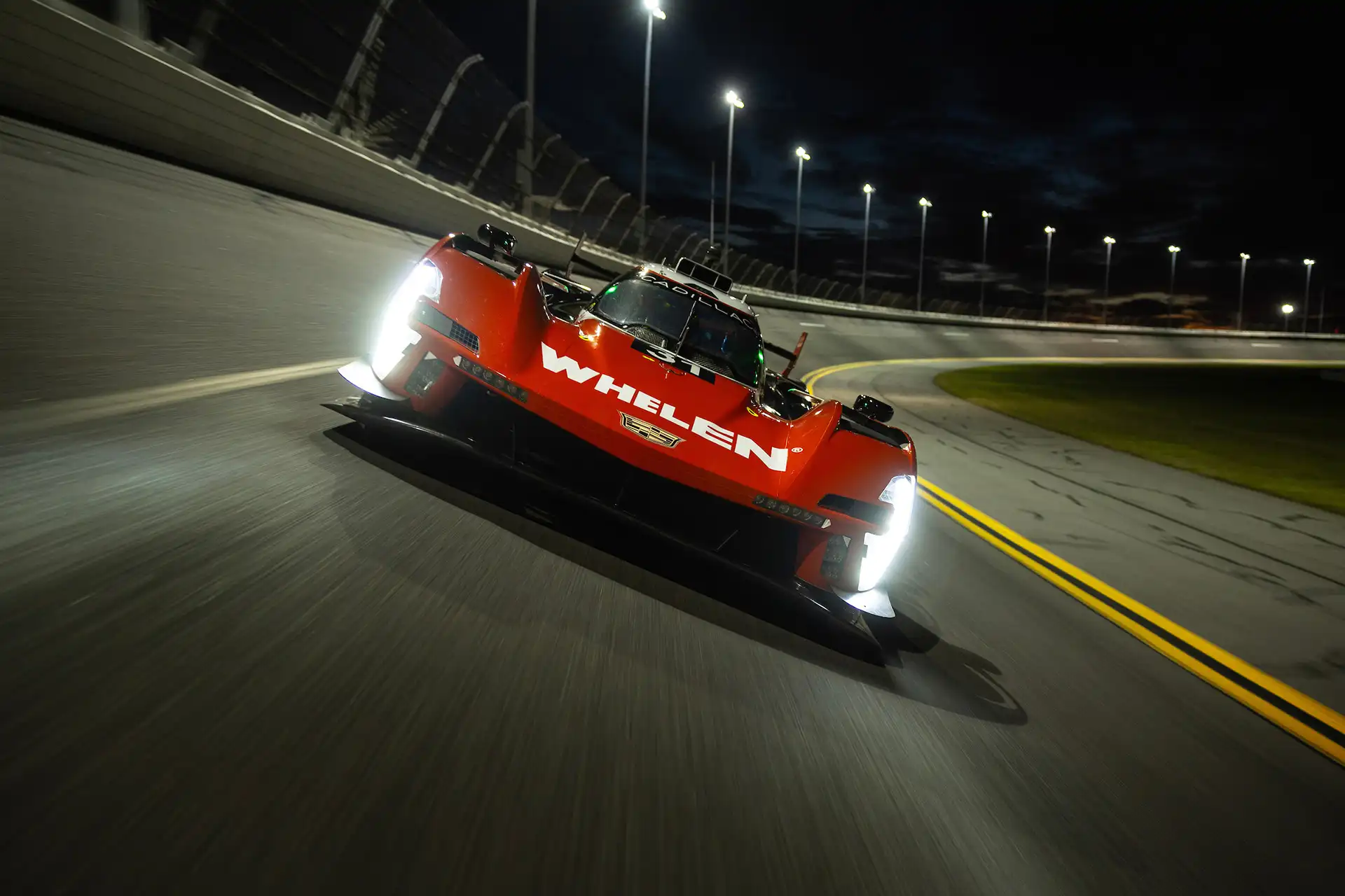 A red racecar driving toward the camera.