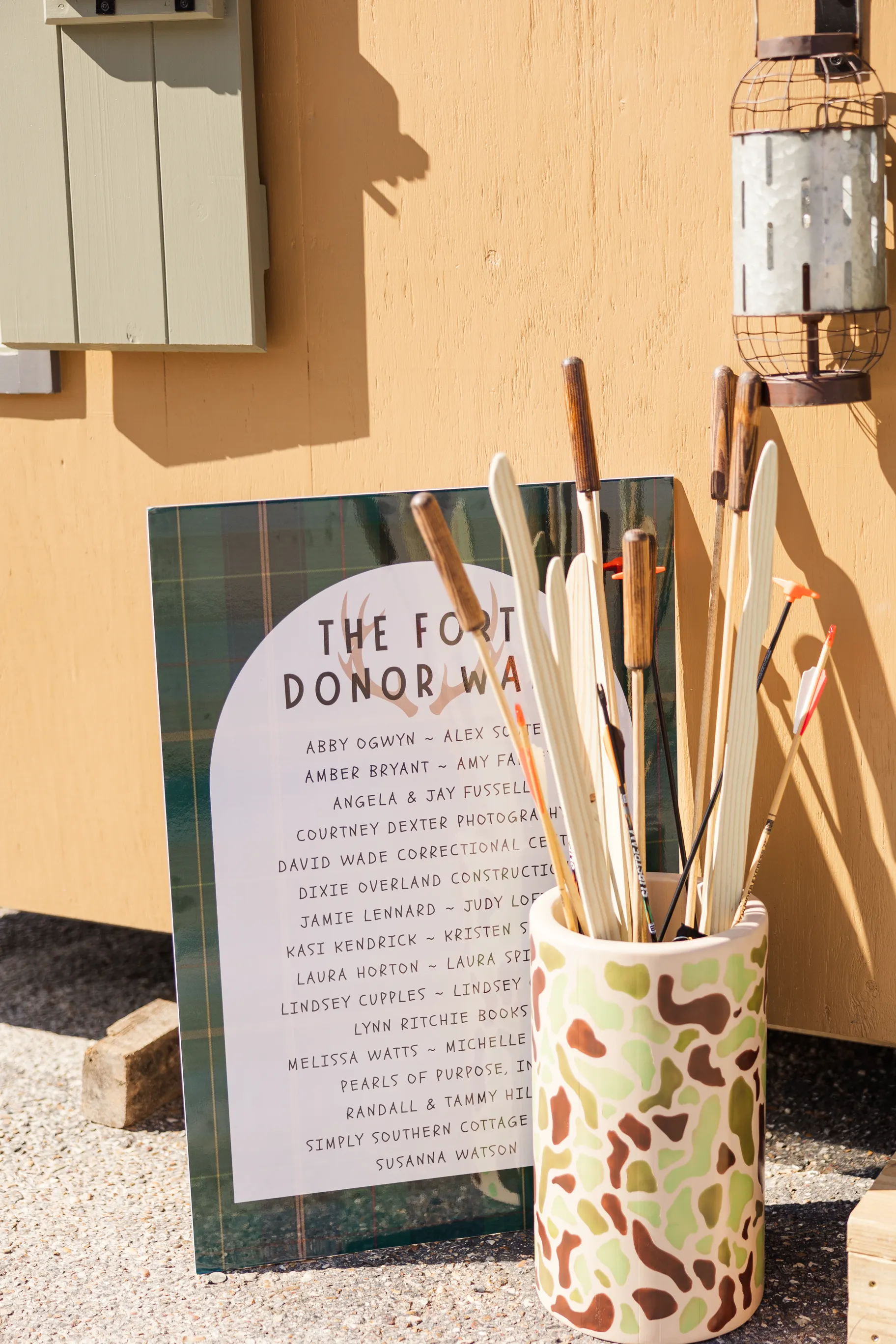 Luxury table setting by Sarah Overall Events with pink embroidered napkins, gold-rimmed plates, floral arrangements, and personalized menus in Shreveport.