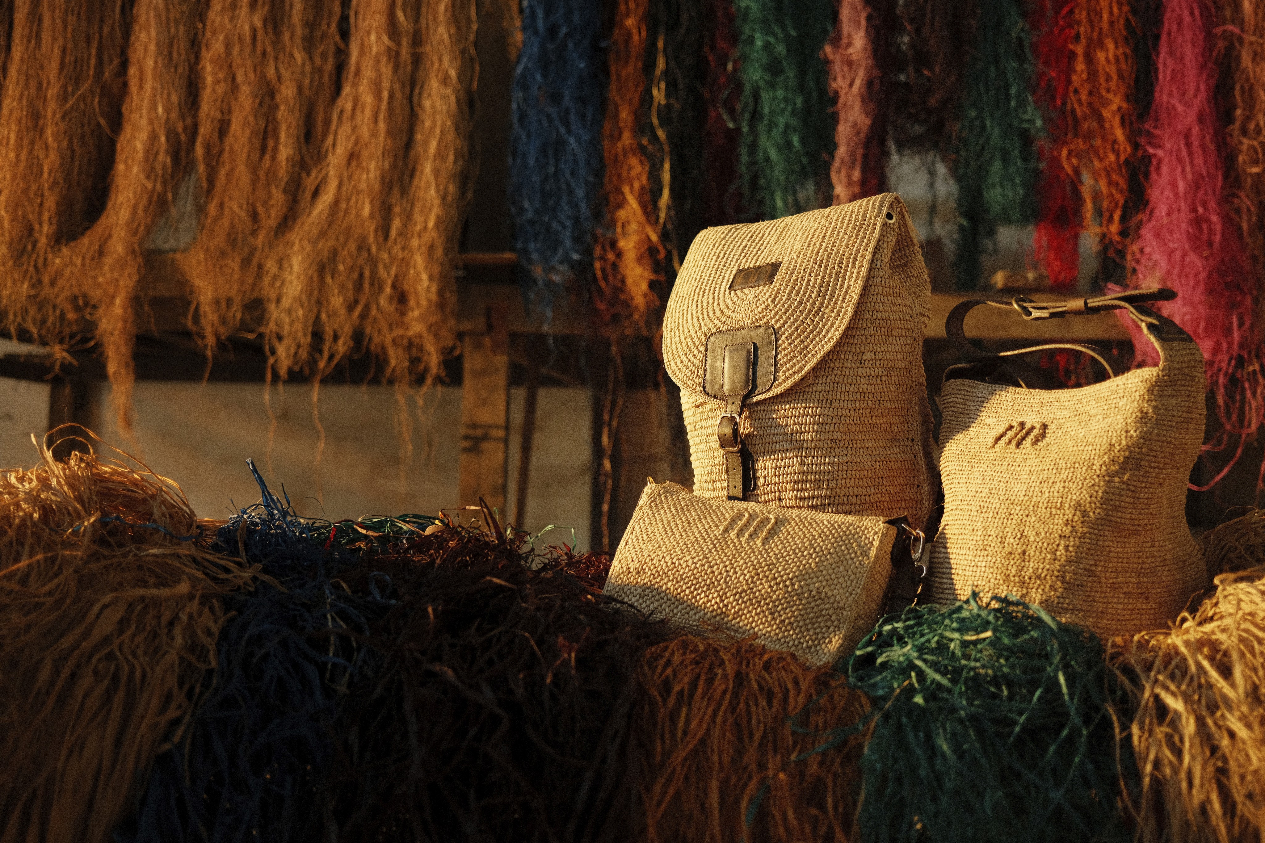 A photo of three raffia travel pieces made by JELYNNE