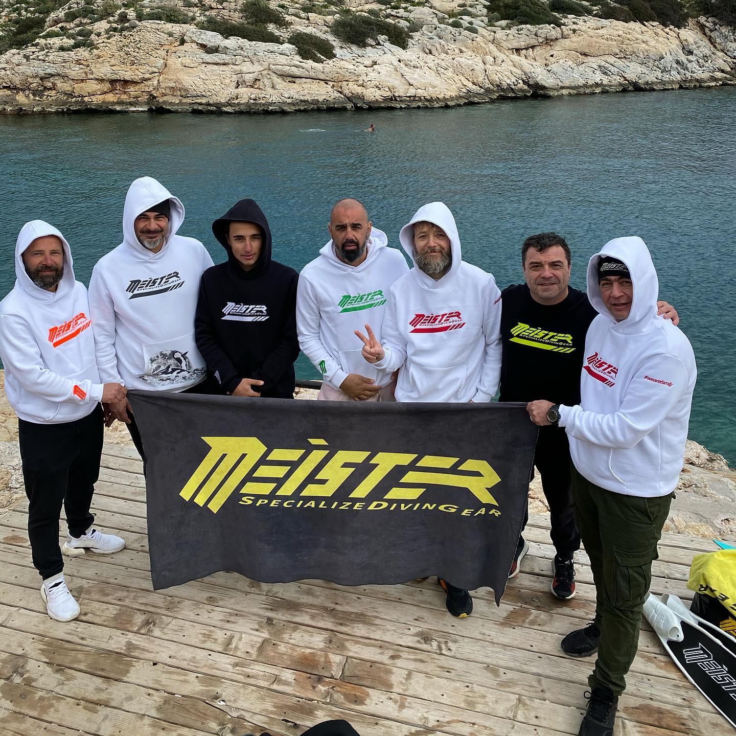 a group of men holding a meister towel