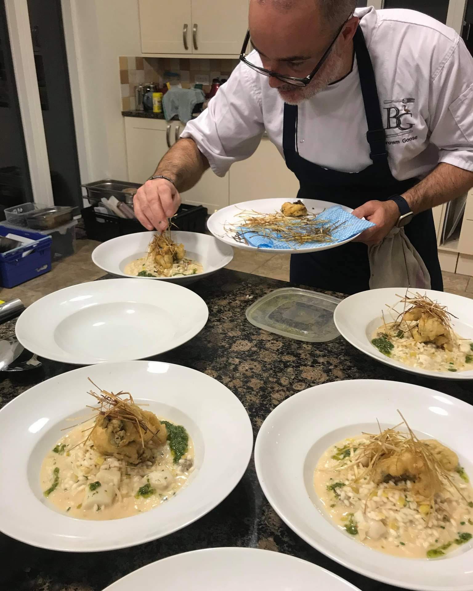 Chef plating food in a kitchen
