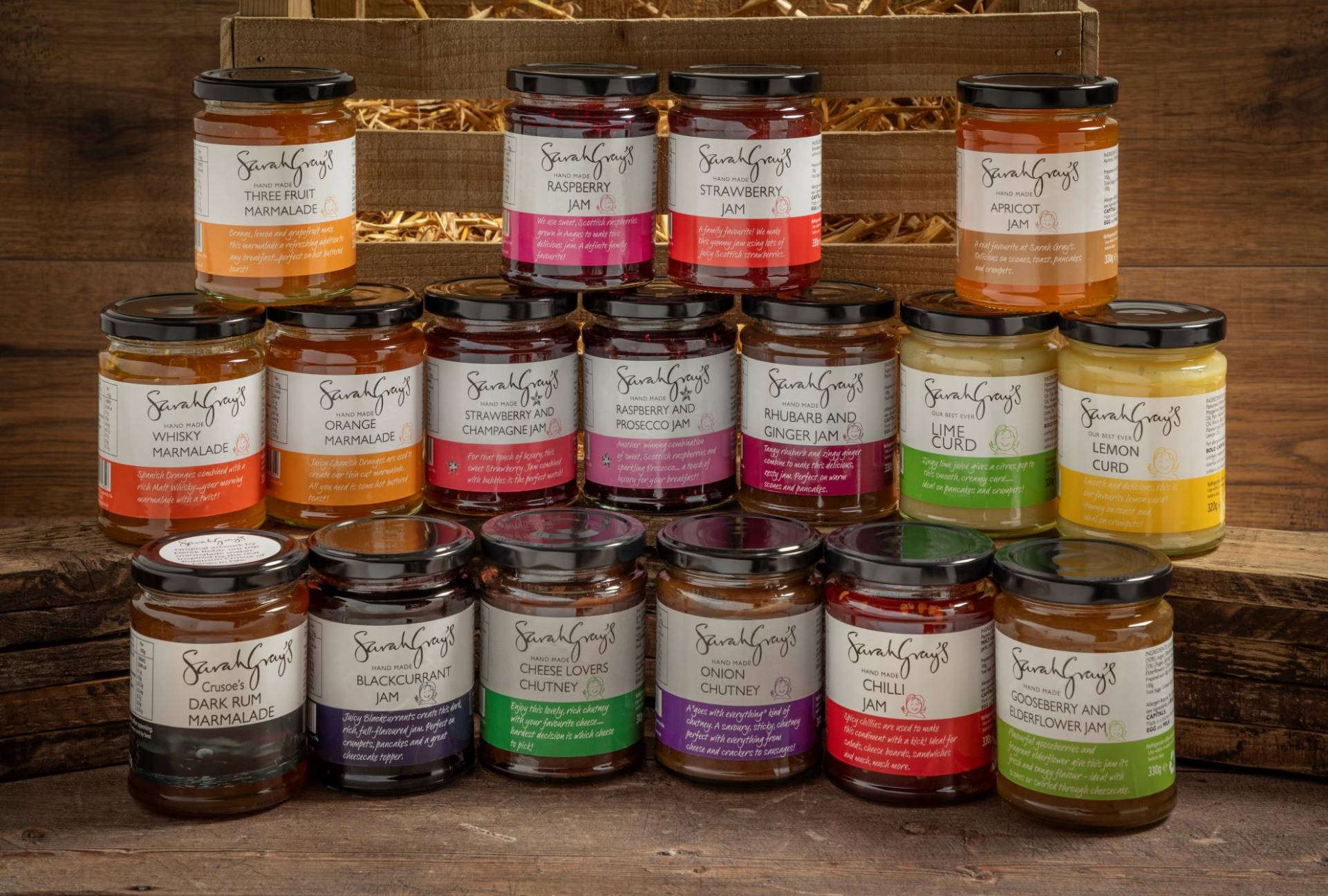 Every Sarah grays Jam jar  stacked in a pyramid style sat on  oak wooden shelves