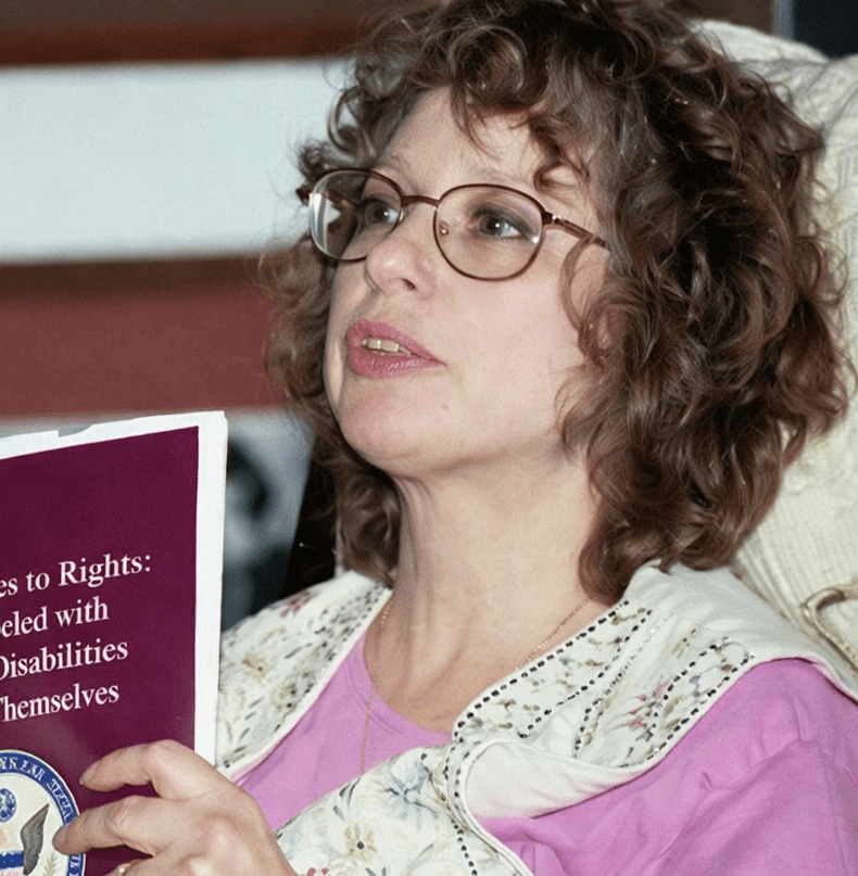 Scientist using a multi-channel pipette to transfer liquid samples in a lab, wearing gloves and surrounded by lab equipment.