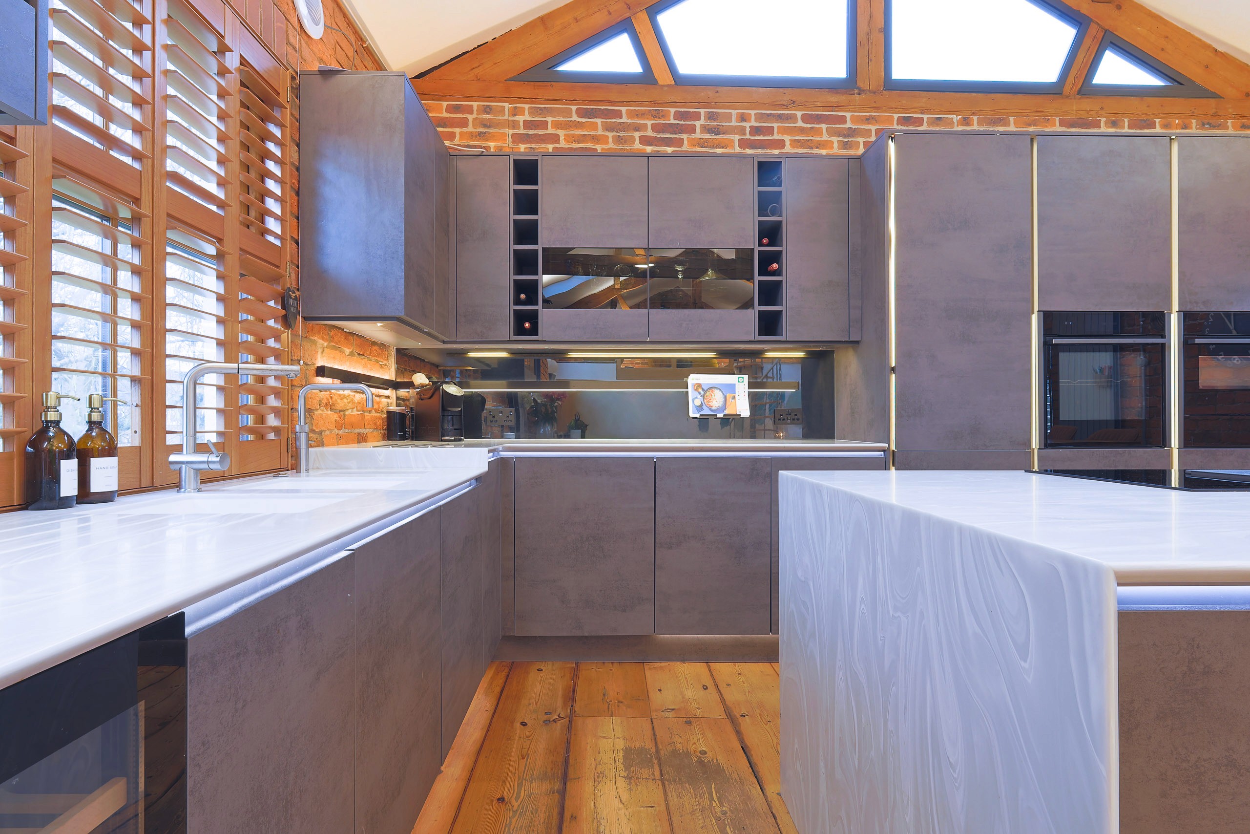 modern handleless concrete kitchen with corian worktops in wilmslow cheshire 