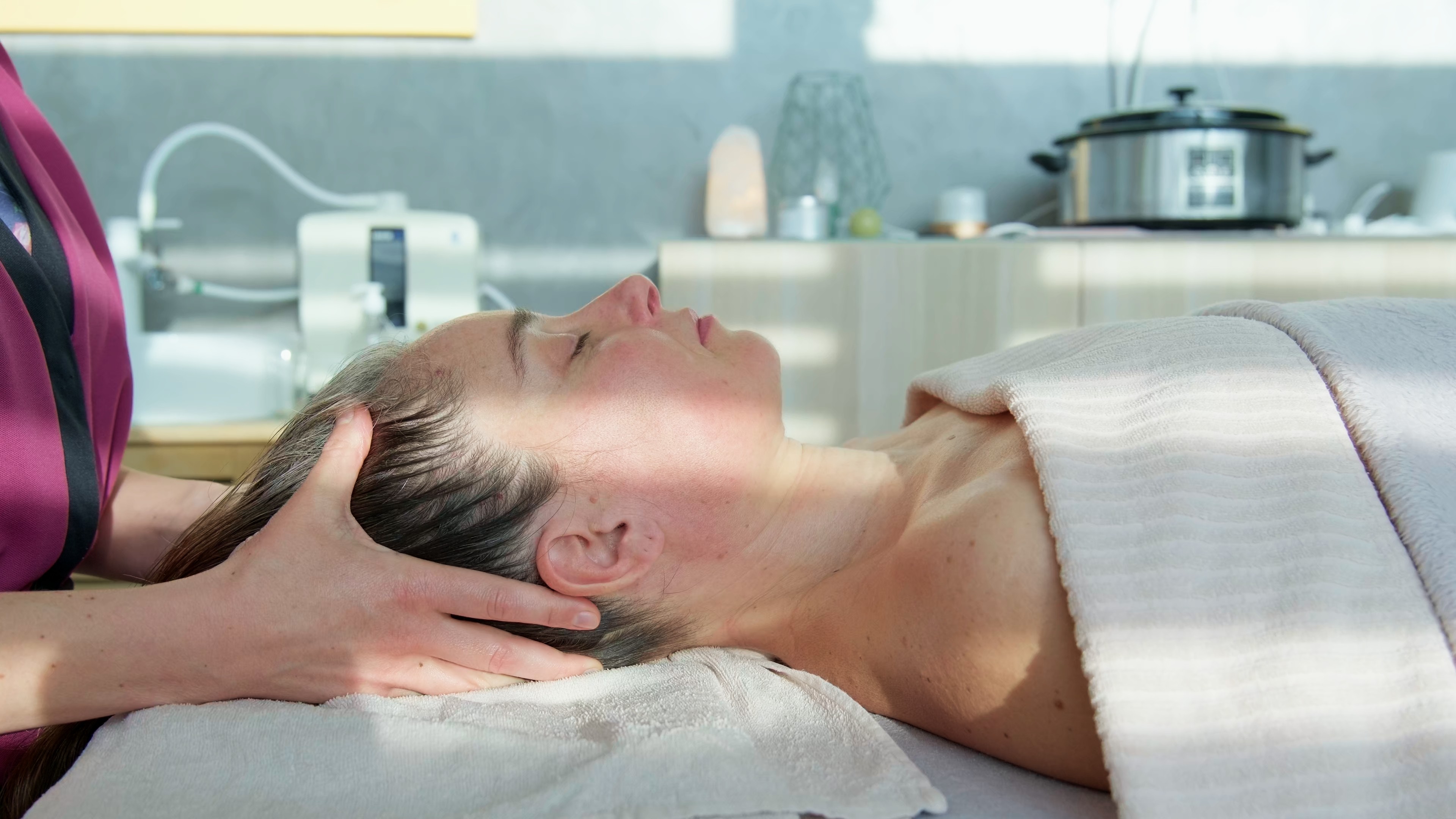 Sand dunes meet the ocean under a clear blue sky.