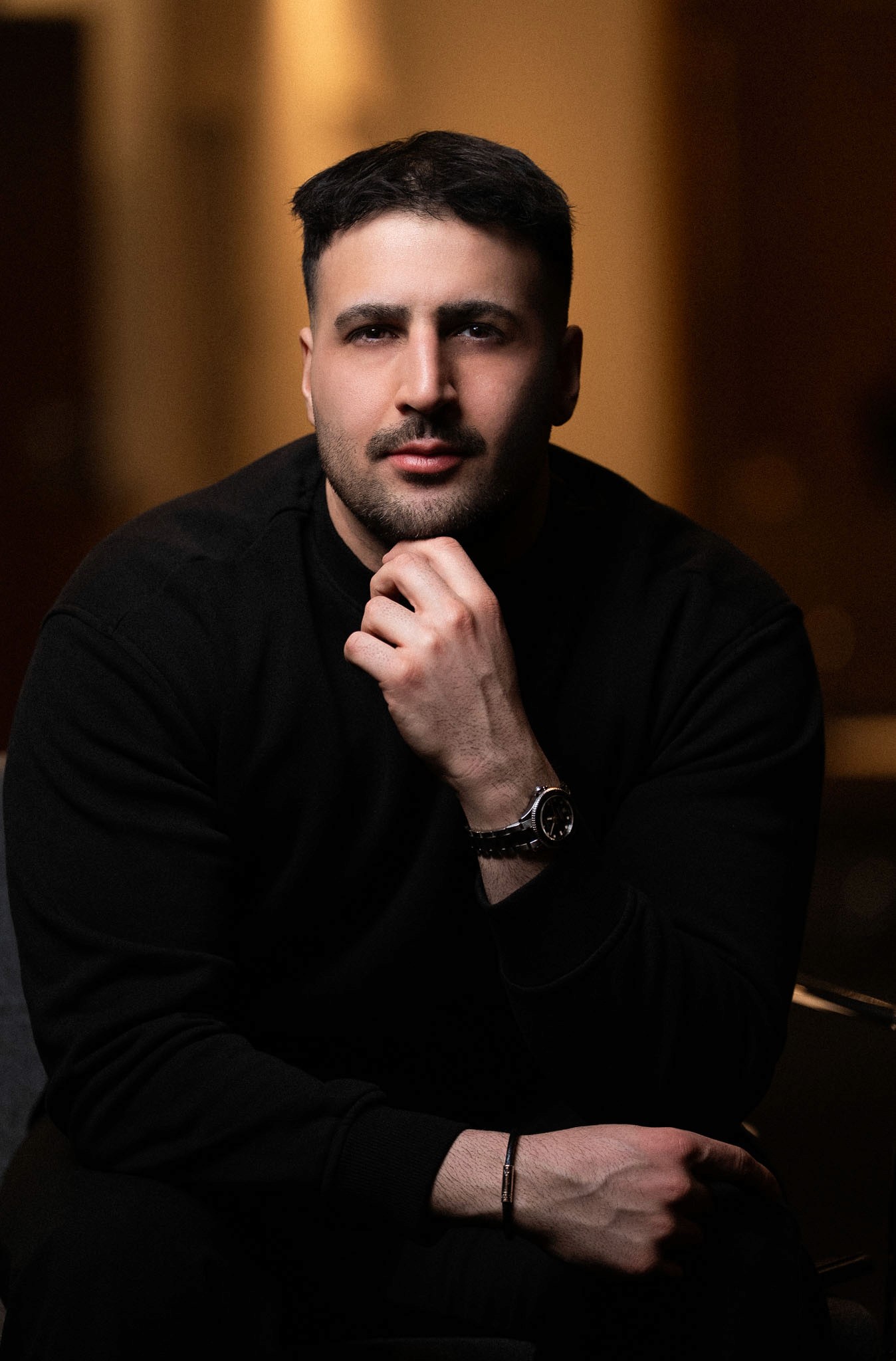 Close-up of runners' legs and colorful sneakers sprinting on a red track.