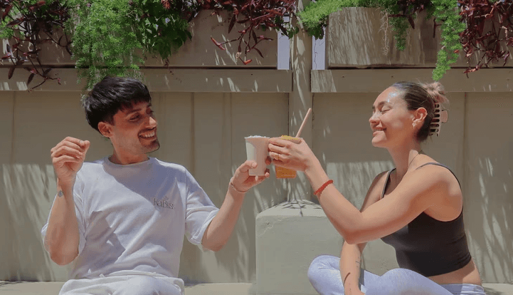 Two people stretching on yoga mats