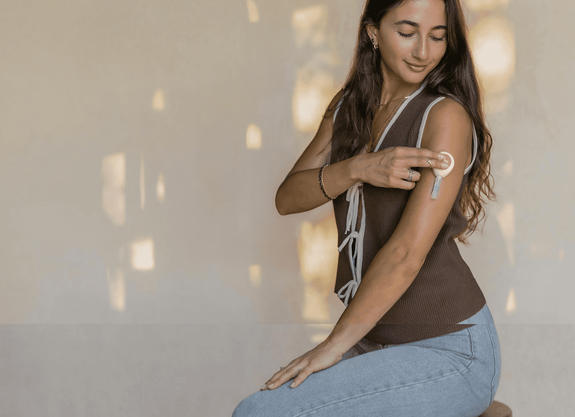 Woman collecting a blood sample from his upper arm using an at-home test kit.