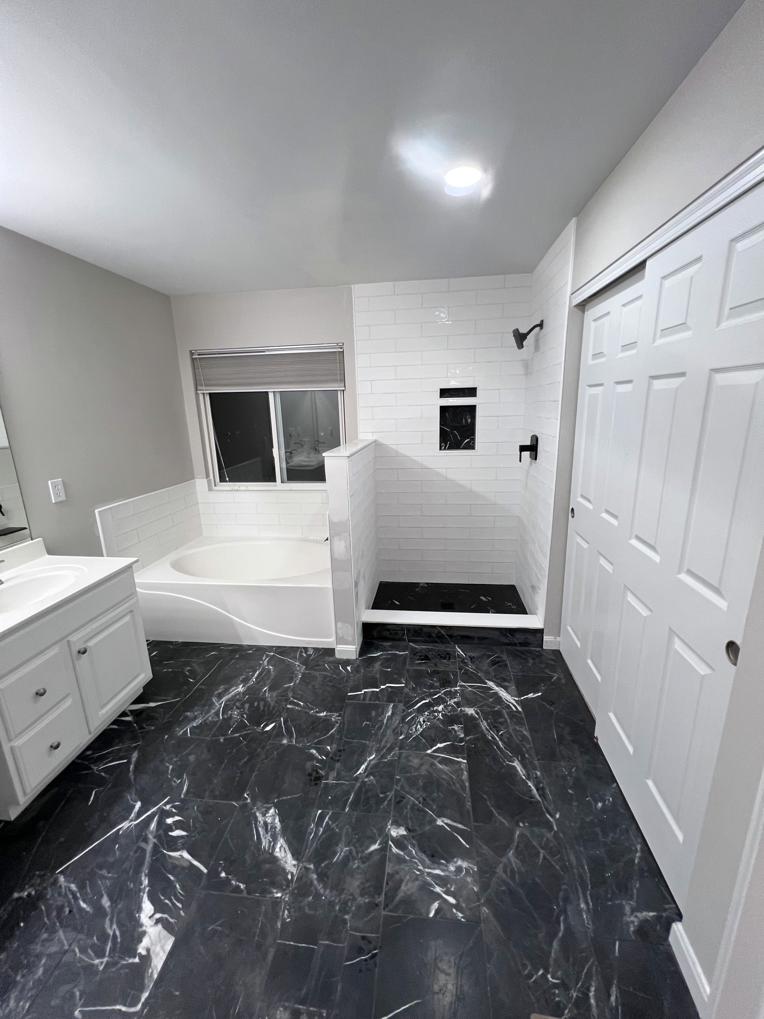 Subway Tile Shower and Tub Surround with Natural Stone Floor 