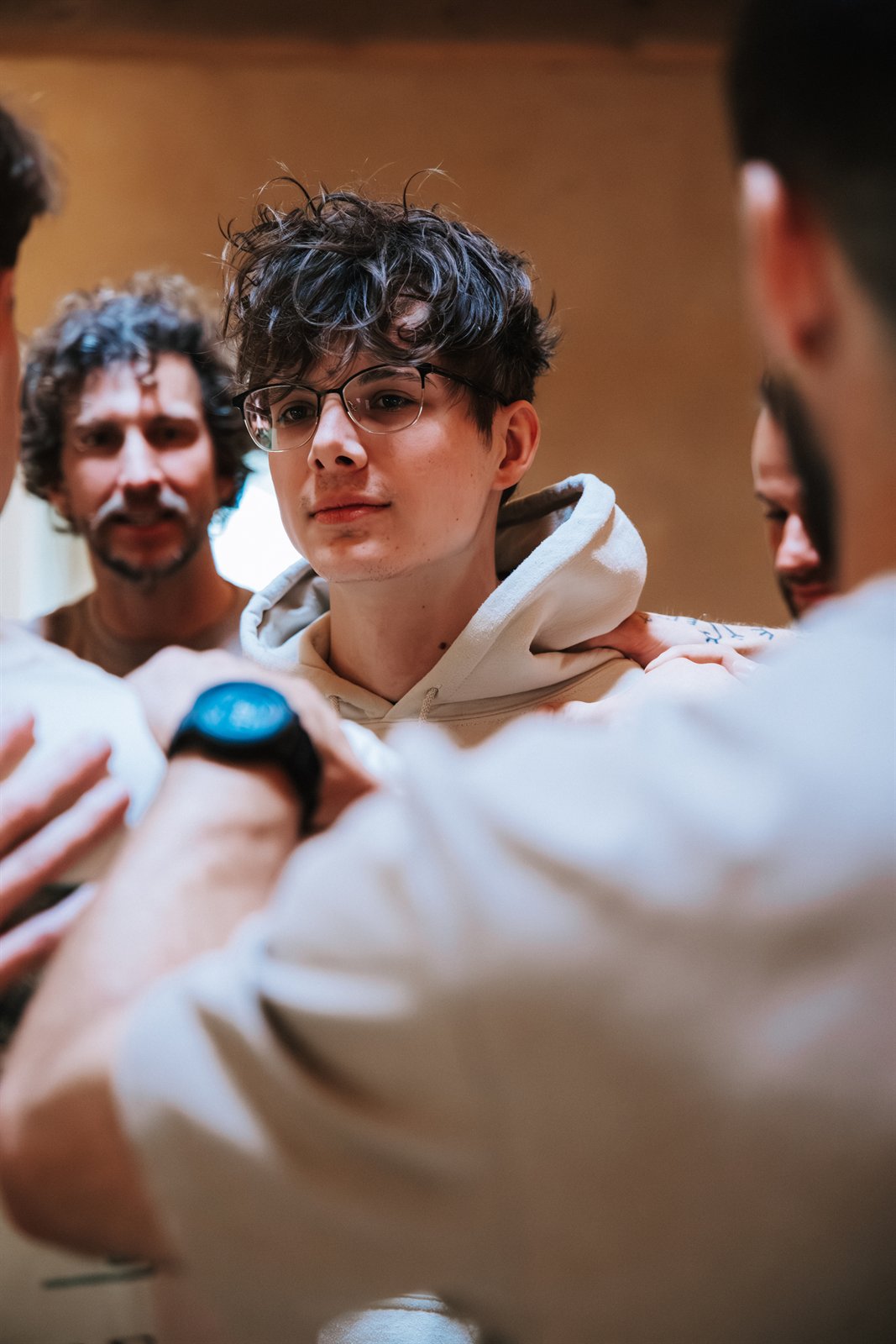 Mannen leggen een hand op de schouders van Quint bij Broederschap