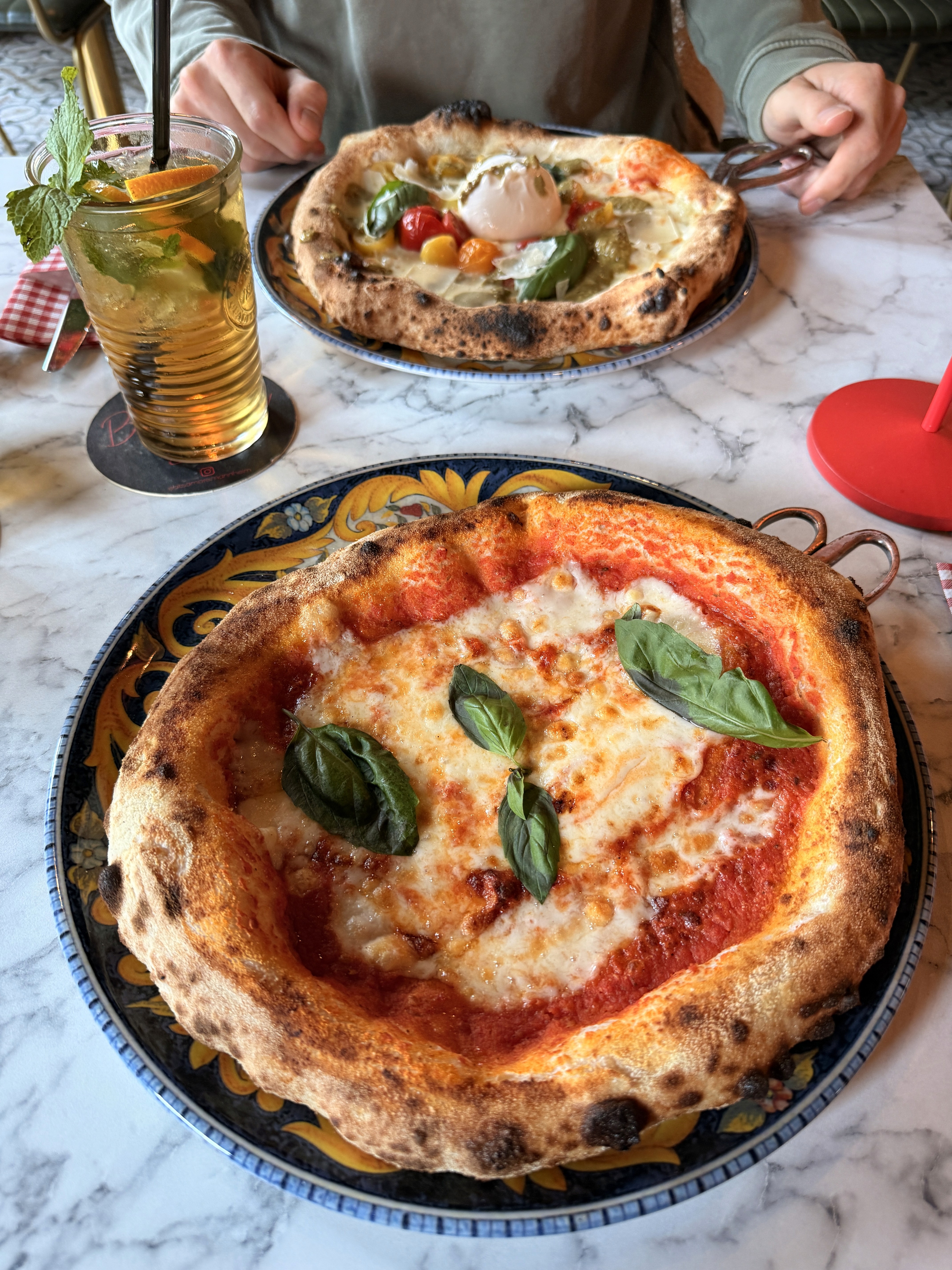 Two people talking on a rooftop at sunset