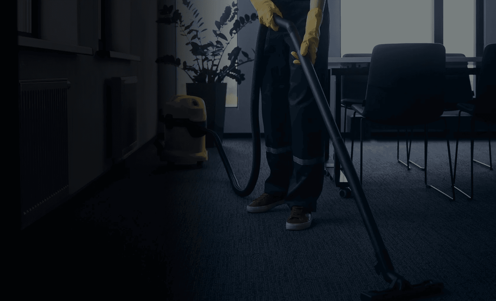 Professional cleaner vacuuming office carpet with industrial equipment Kerry