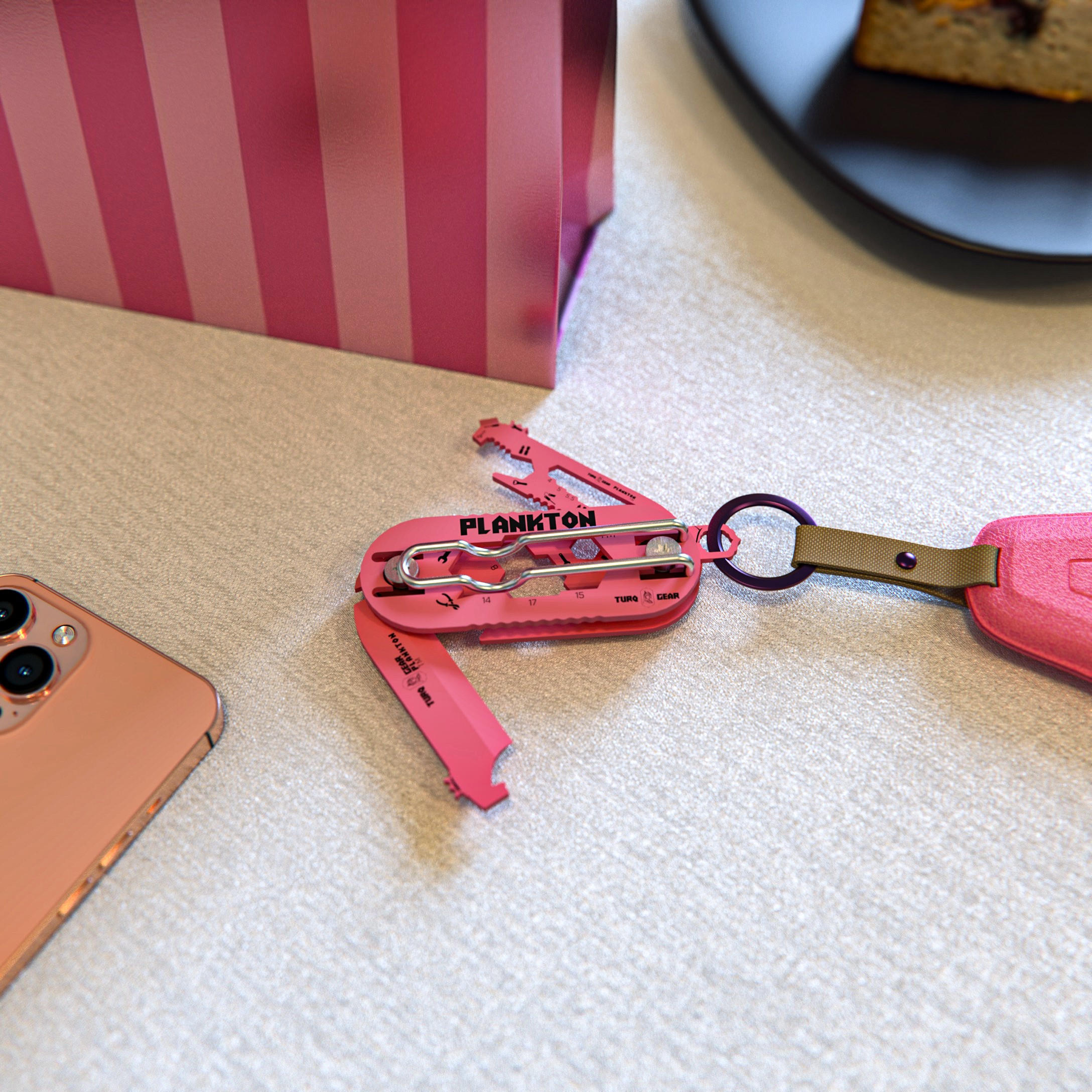 High-fidelity render of the pink Turq Gear 'Plankton' multi-tool with a keychain attachment. Showcases the brand's bold color strategy and material finish, targeting a diverse audience through modern industrial design aesthetics.