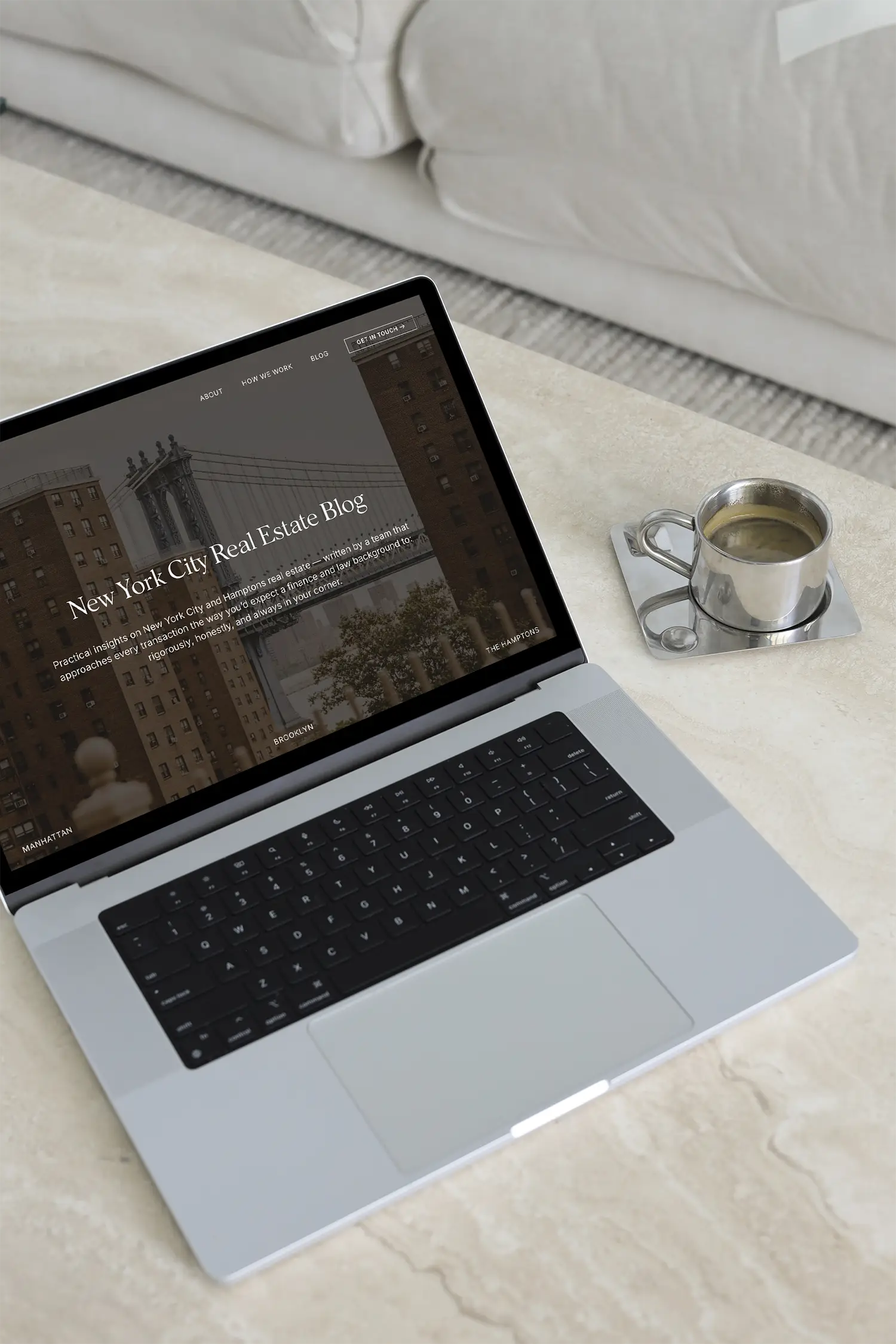 A open laptop sitting on a marble tabletop