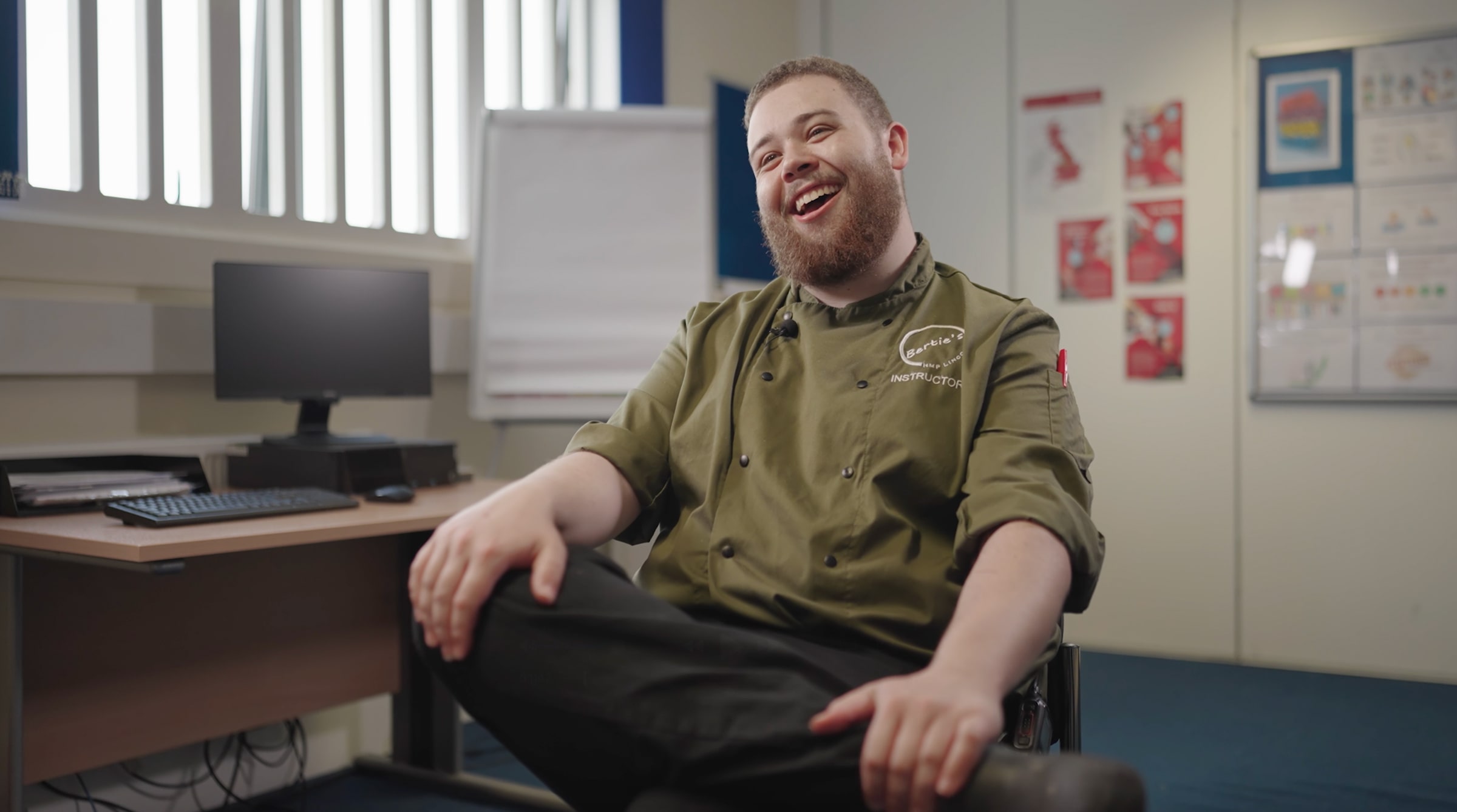 An interview shot from the documentary served, showing Nick the chef smiling as he sits in a chair