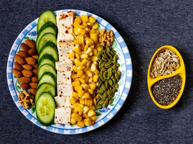 Minimal plate with small portions of vegetables, nuts, and healthy fats representing a fasting mimicking meal.