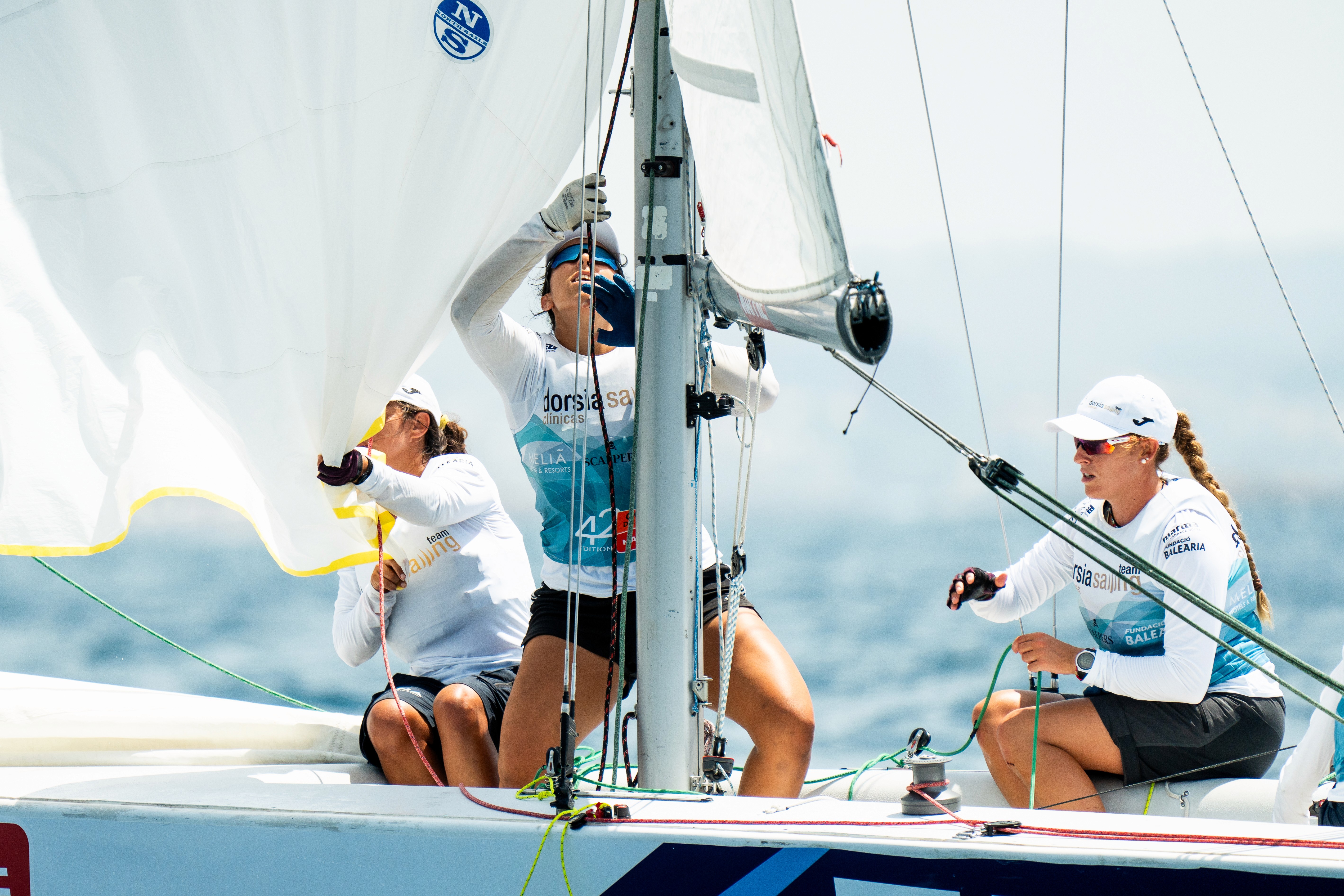 A woman in a helmet with a light trail, suggesting movement or speed in a dynamic outdoor setting.