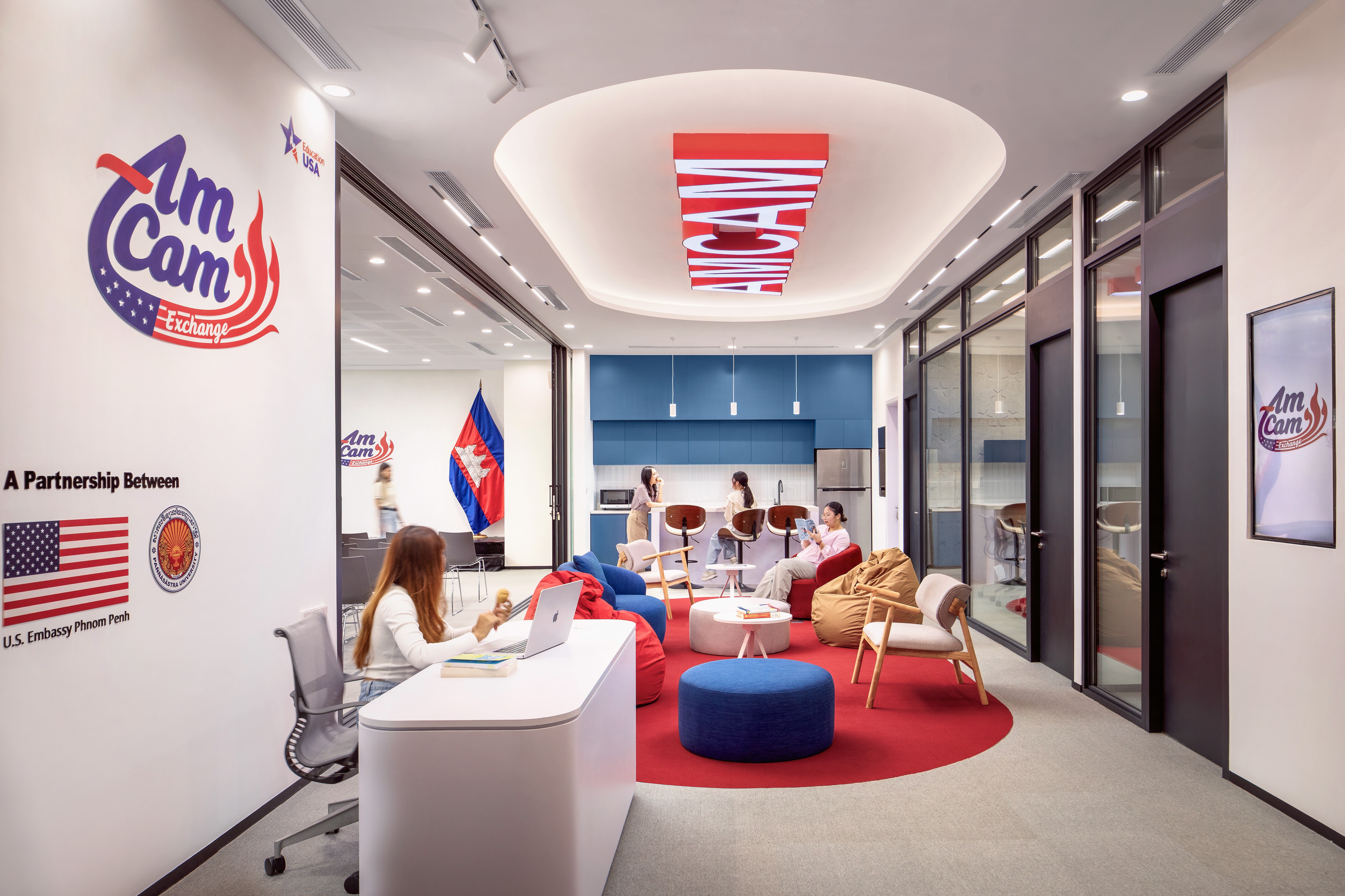 Integrated reception area featuring an informal lounge with bean bags, modular seating, and a collaborative pantry zone to support community engagement