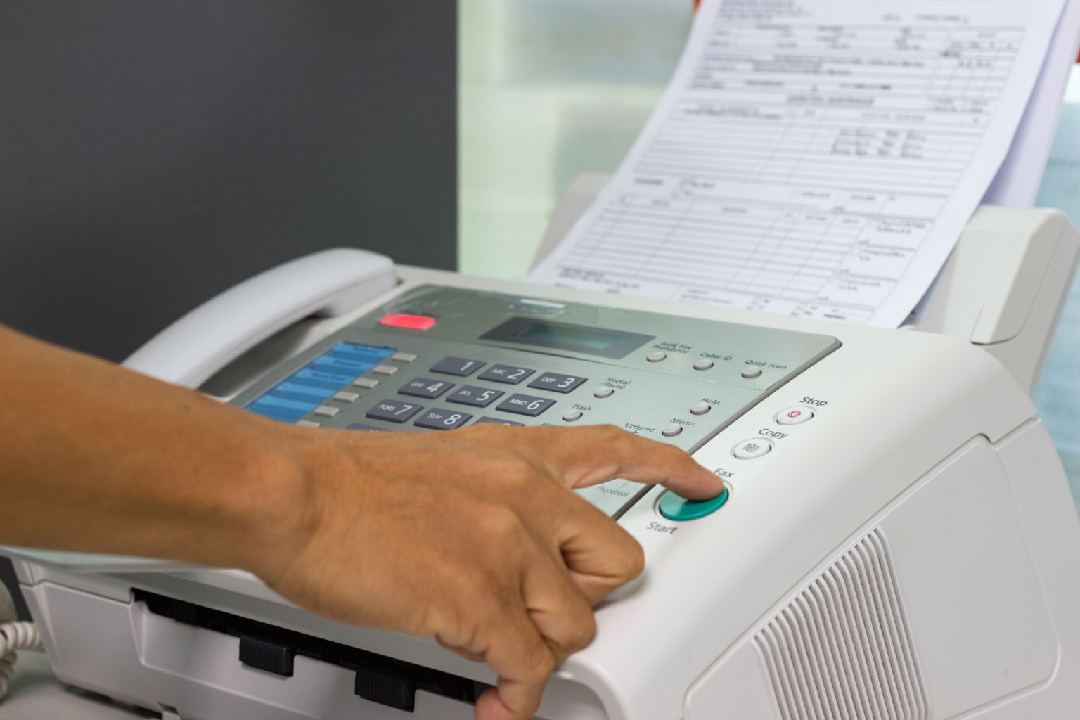 person using a fax machine