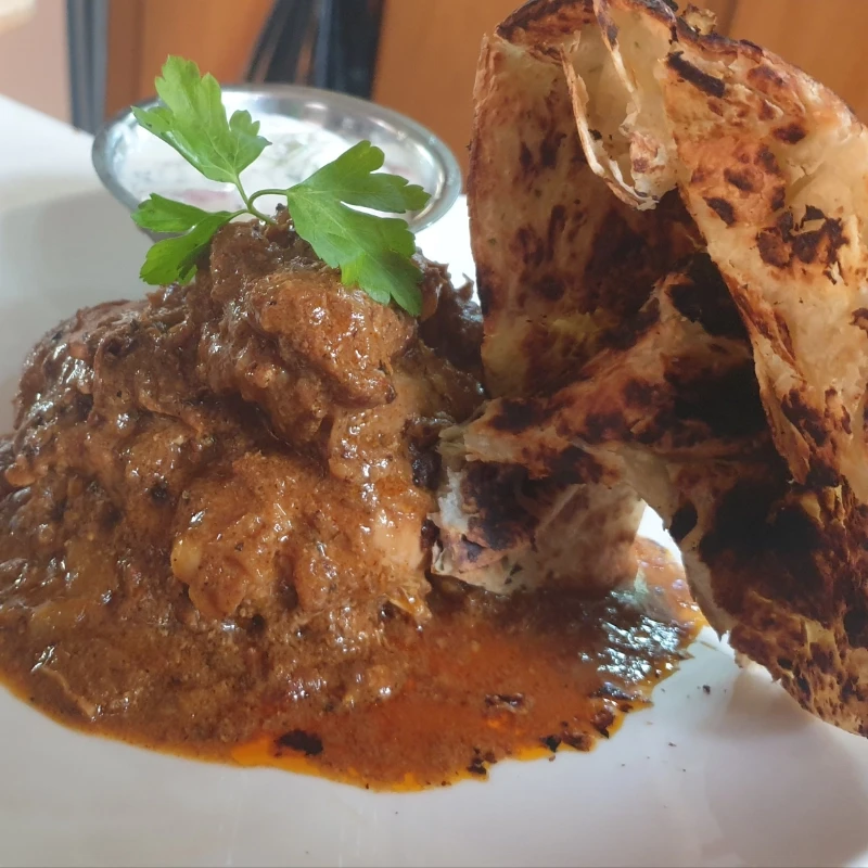 South Indian Chicken Curry with crispy naan.