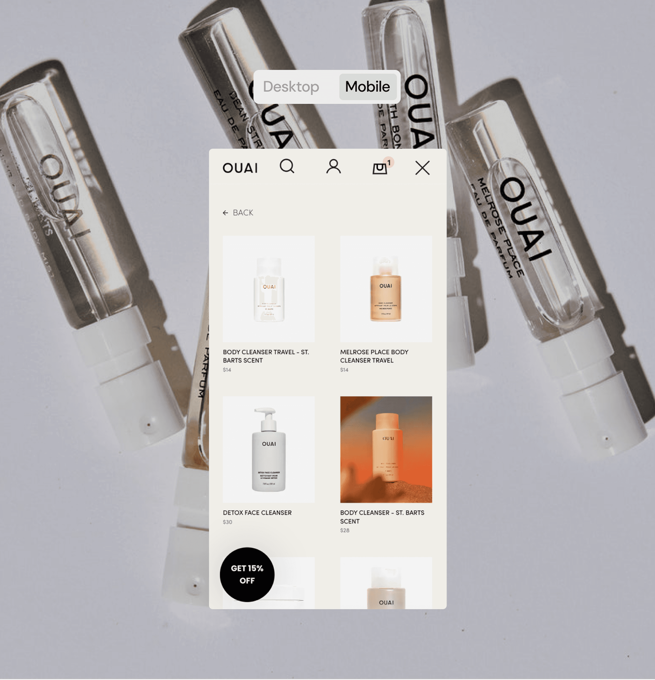 A mobile e-commerce interface for the OUAI brand is displayed over a background of OUAI perfume sample vials. The interface shows a product listing with images and prices for items like “Body Cleanser Travel – St. Barts Scent,” “Melrose Place Body Cleanser Travel,” and “Detox Face Cleanser.” A promotional badge at the bottom left reads “GET 15% OFF.” At the top, navigation icons include search, account, and shopping bag, with "Mobile" selected in the view toggle.
