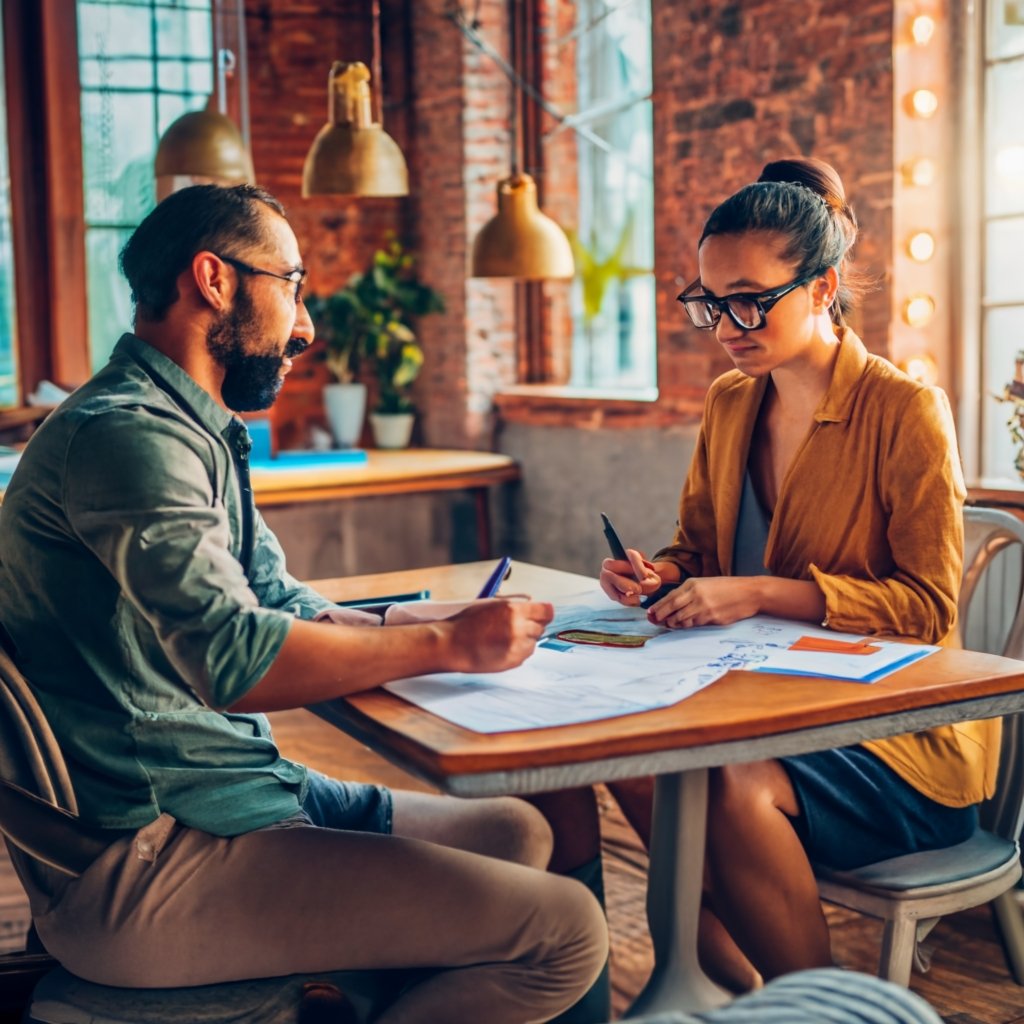 A couple or family sitting at a table, filling out Form
