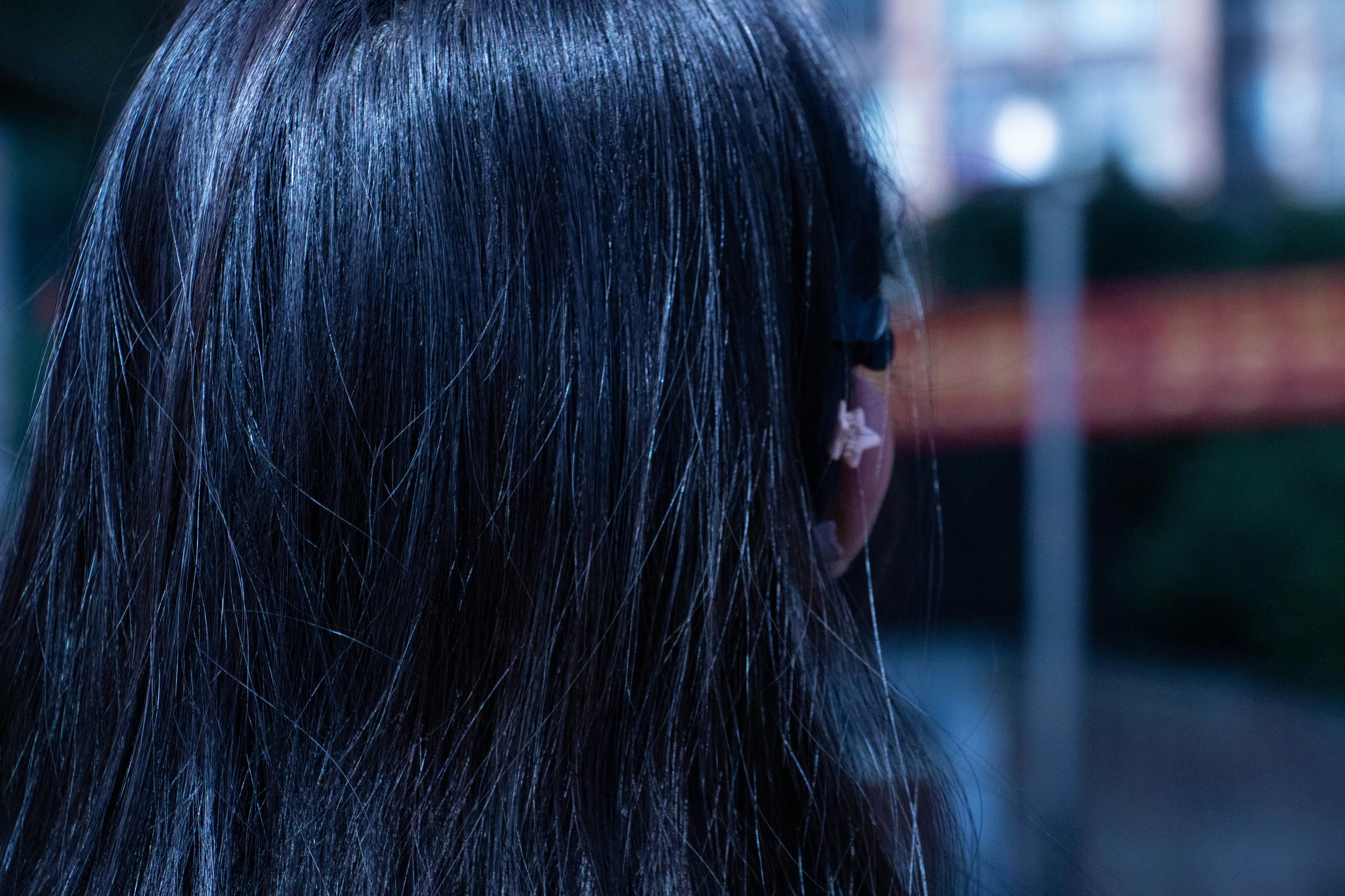 The back of a woman's head with long black hair