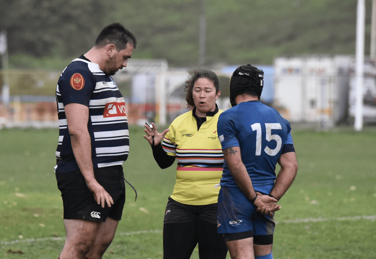 two players and rugby referee